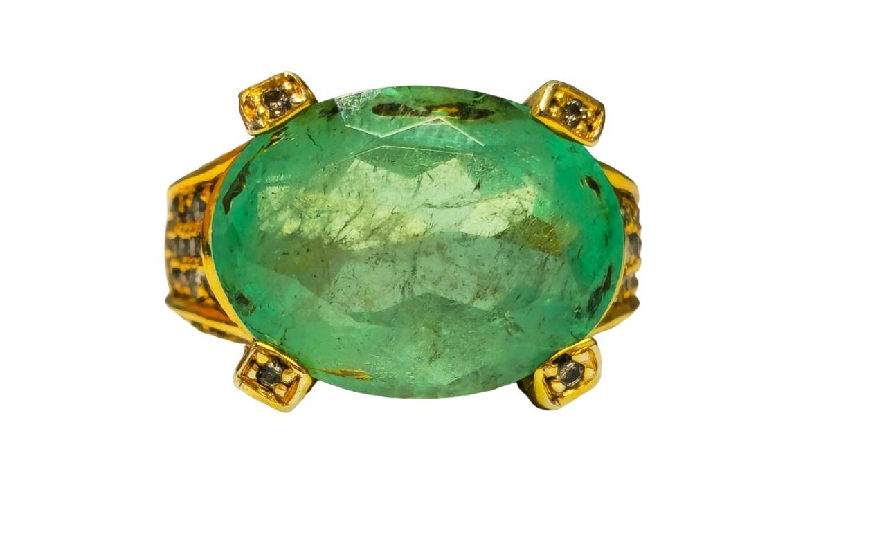 Elevate your style with our exquisite 14K Yellow Gold Colombian Emerald Ring, boasting a stunning 11.50 carat oval-cut emerald of unparalleled quality, set securely in prongs to showcase its deep and intense saturation. Accentuated by 1.50 carats of