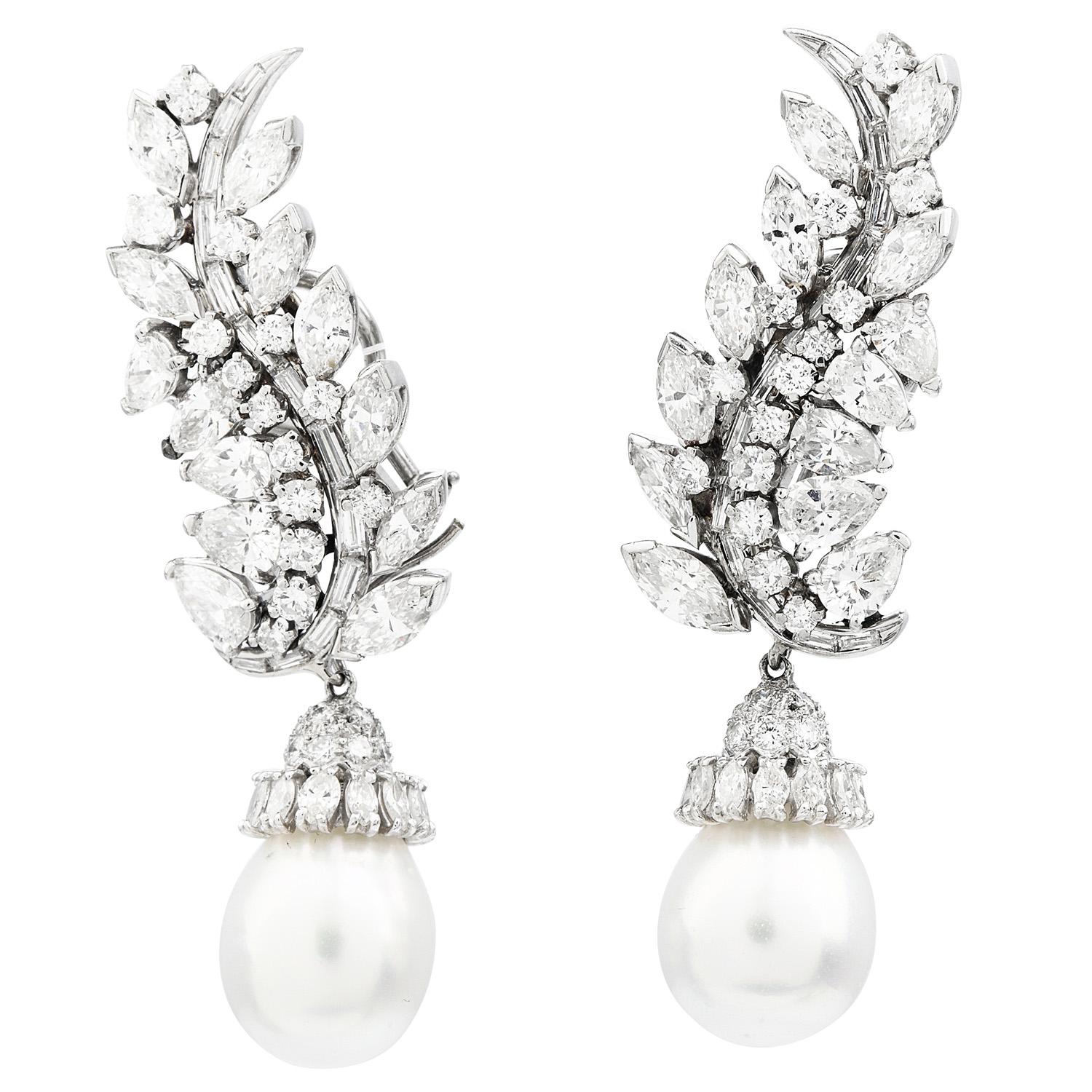 This is a stunning pair of Day and Night South Sea Pearl & Diamonds Botanical Leafs Motif Dangle Drop Earrings weighing approximately 28.6 grams.

Exquisitely crafted in luxurious platinum, featuring (2) outstanding Genuine South Sea Pearls