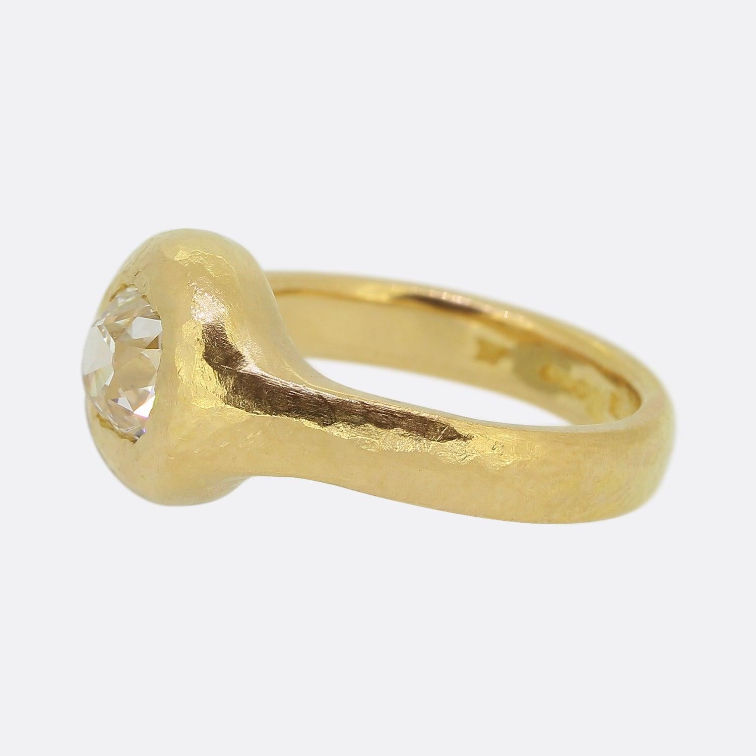 Here we have an outstanding single stone diamond ring. As expected from 22ct gold, a rich gold colour-tone is on show here with the piece featuring an entirely hammered finish from the band to the front setting which plays host to a tremendous