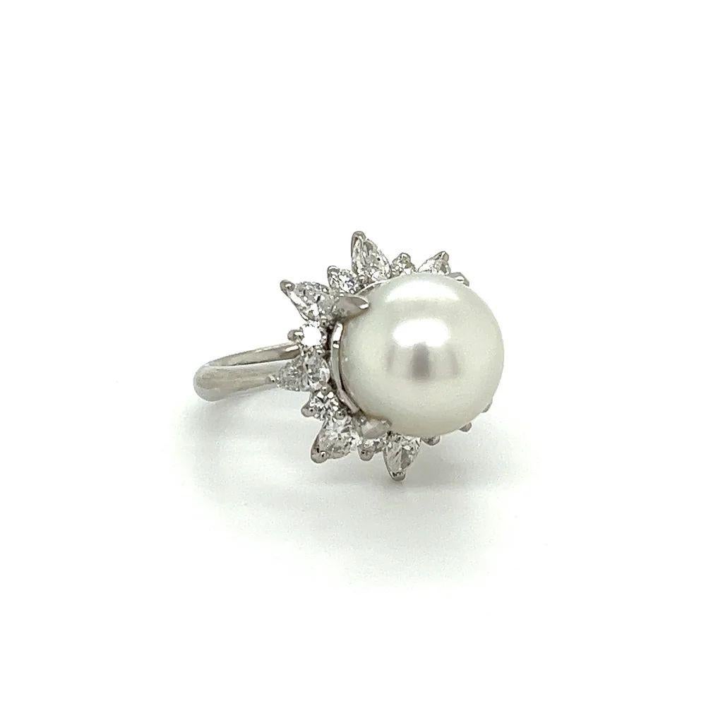 Simply Beautiful! Finely detailed White South Sea Pearl and Diamond Cocktail Ring. Centering a securely nestled Hand set 11.7mm White South Sea Pearl surrounded by approx. 1.34tcw Marquis and Round Diamonds, all white and clean cascading down as an