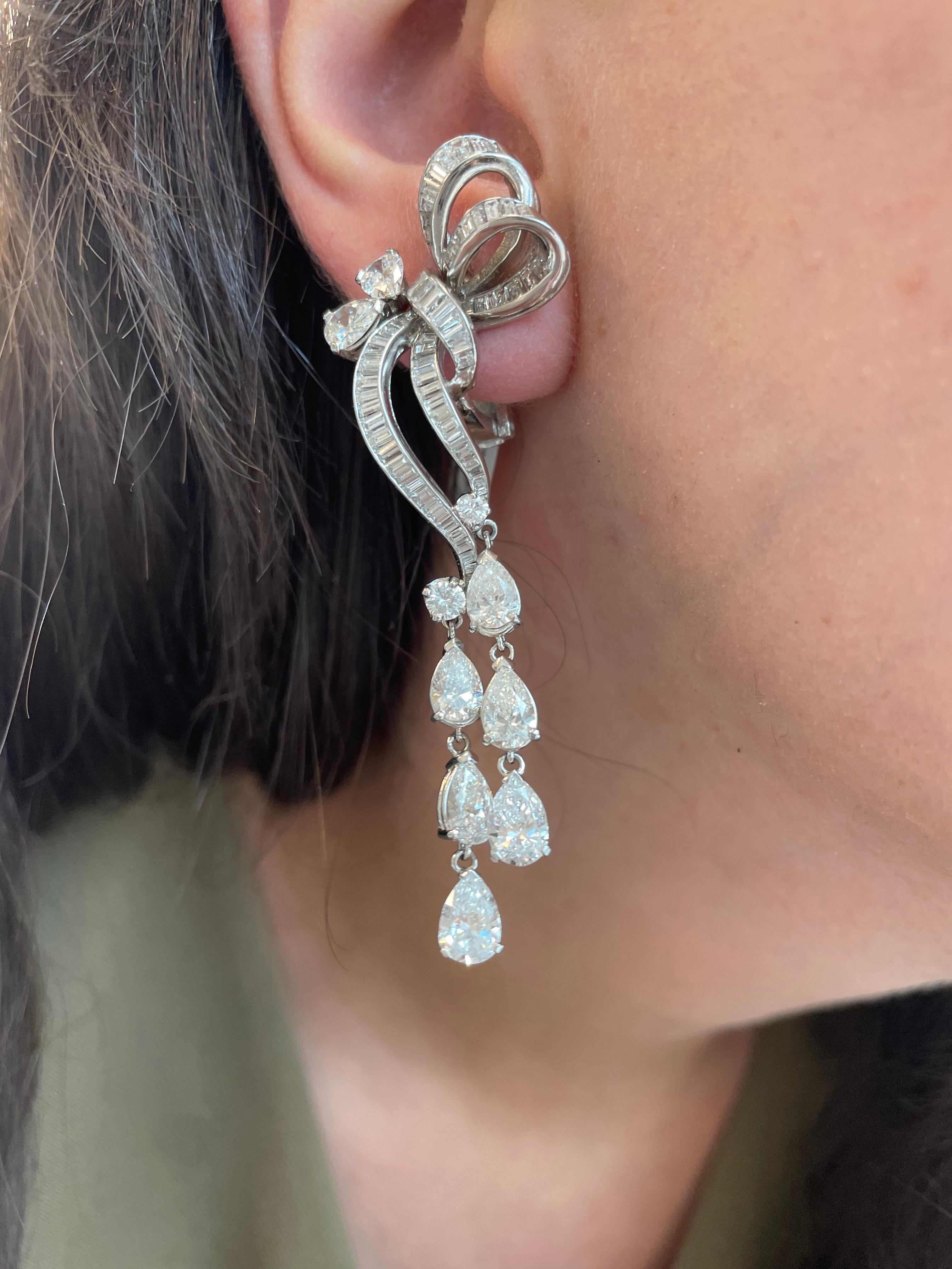 Stunning vintage chandelier high jewelry earrings. Circa 1960's with modernly added bottom pear shape diamonds .
Approximately 11.95 carats of pear, baguette and round brilliant diamonds. Approximately G/H color grade and VS clarity grade. Platinum,