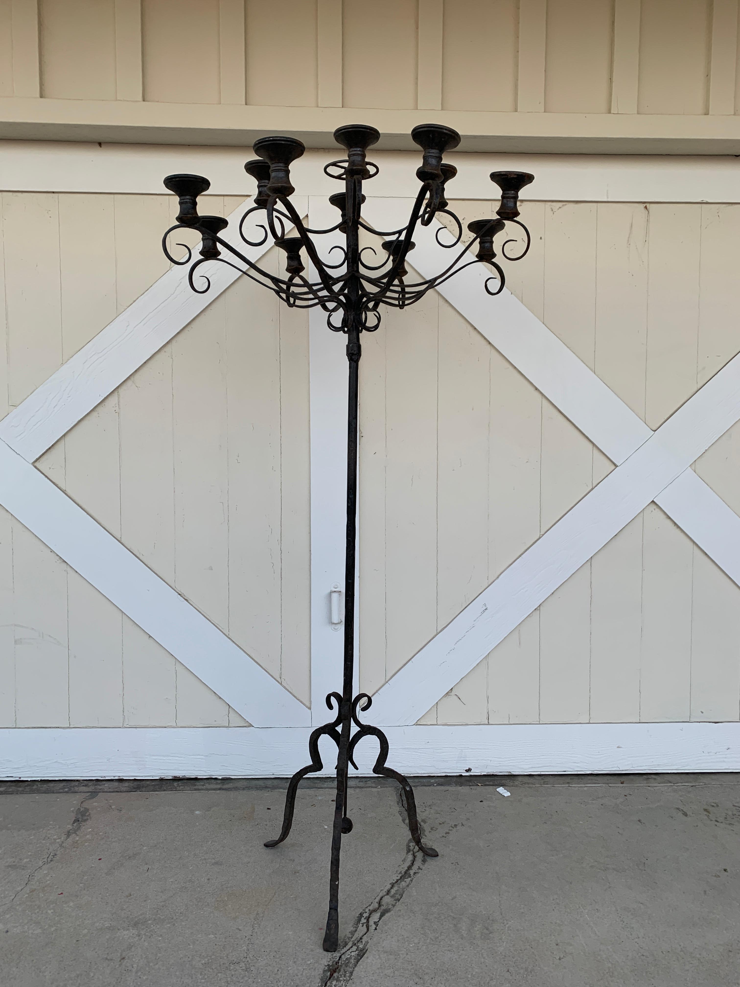 Stunning and one of a king wrought iron candelabra that holds 12 candles.

The piece has beautiful lines and seats on a tripod base.

The top can be removed for transport.

Measurements:
72.50 inches high x 37 diameter x 20 inches wide x 20