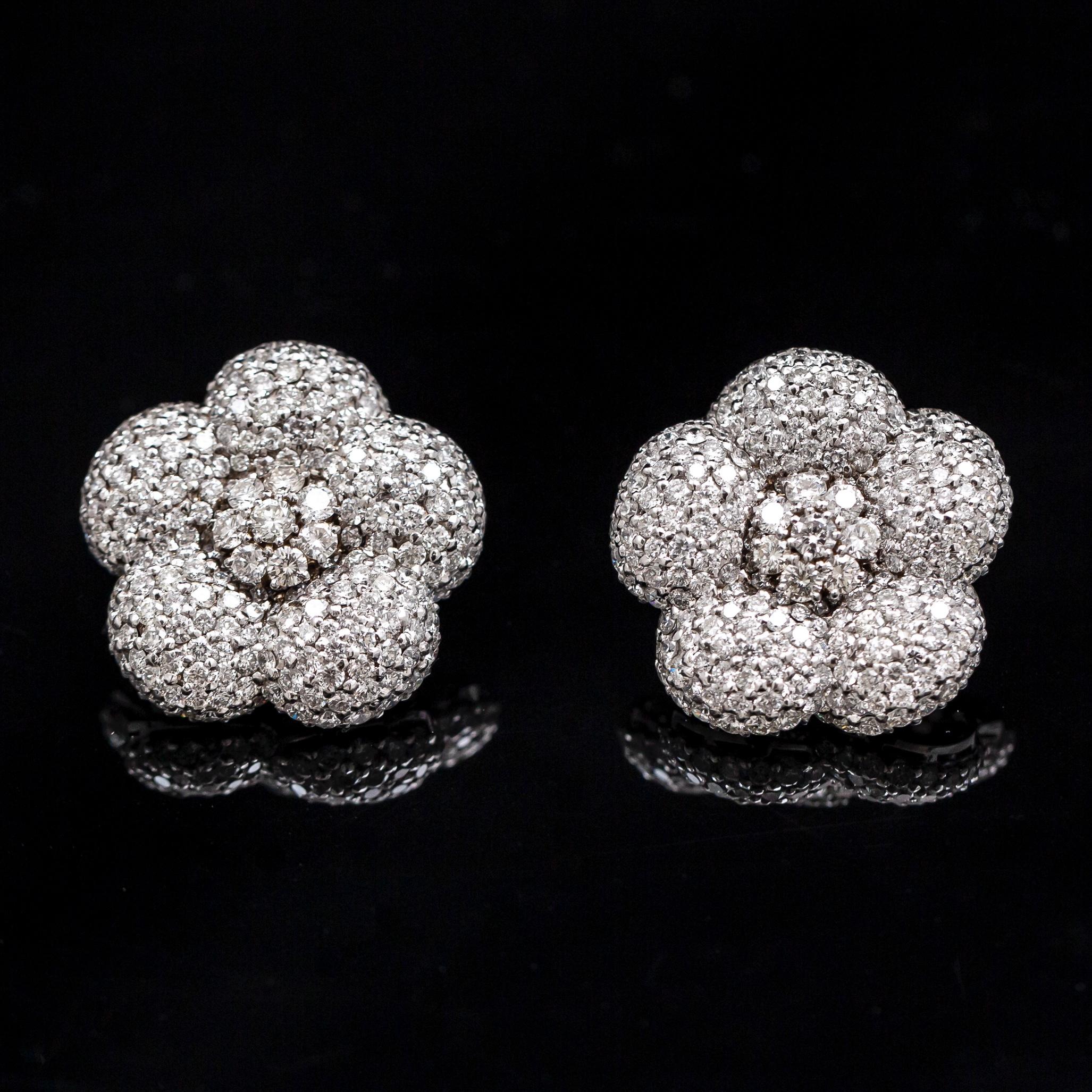 Vintage flower diamond earrings in 19.2kt white gold, Portugal, circa 1990. Each of these elegant floral earrings is composed by five petals pave-set throughout with over 200 round brilliant-cut diamonds, the center further accented with eight