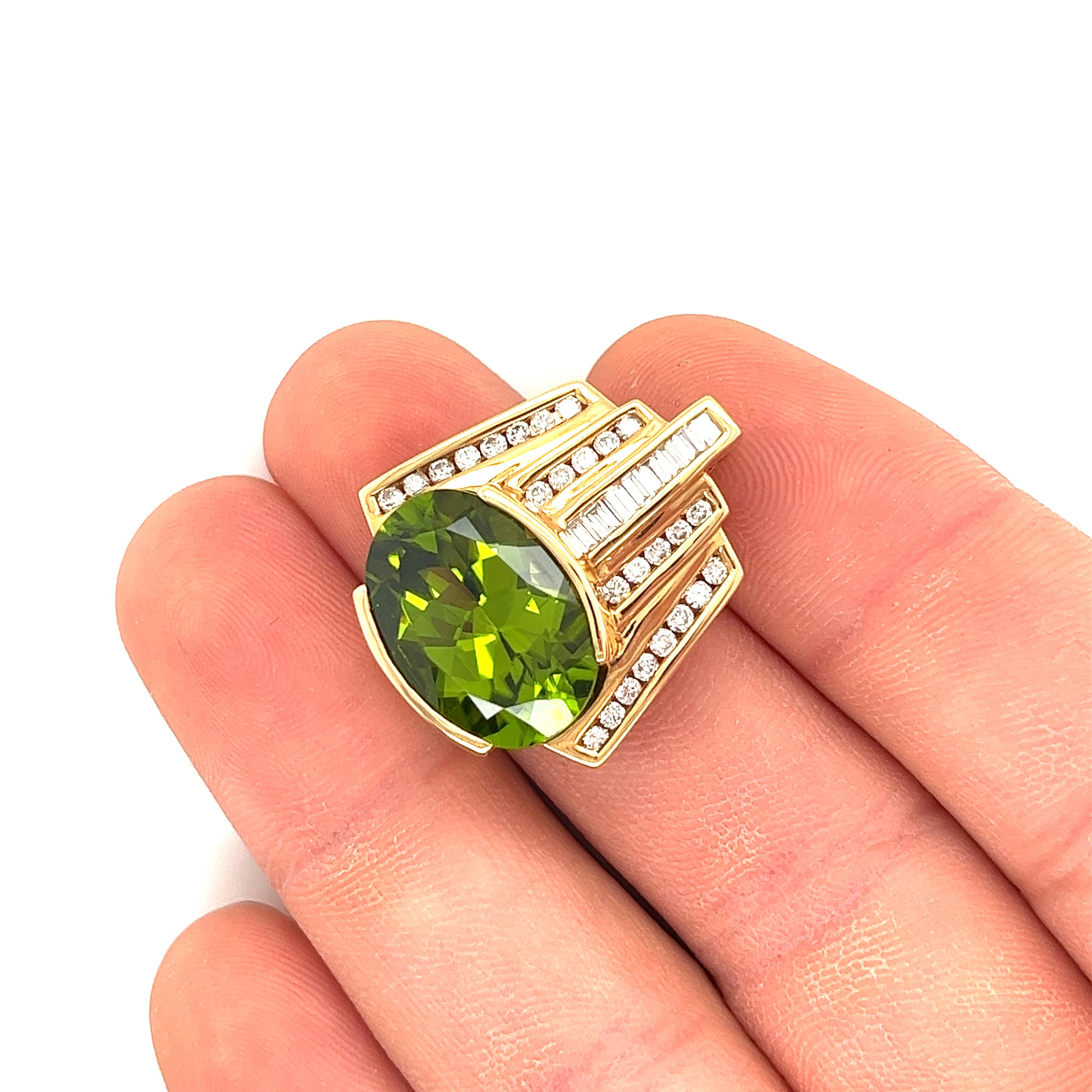 Vintage pendant, with an oval cut green peridot center stone, this pendant is paired with diamond side stones. Secured through channel setting, these baguette and round cut diamonds are placed with an intricate geometric design of white and yellow