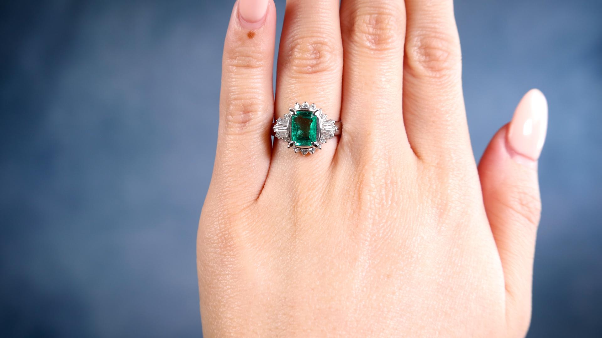 One Vintage 1.20 Carat Emerald and Diamond Platinum Cluster Ring. Featuring one octagonal step cut emerald of 1.20 carats. Accented by six tapered cut diamonds and 14 round brilliant cut diamonds with a total weight of 0.65 carat, graded