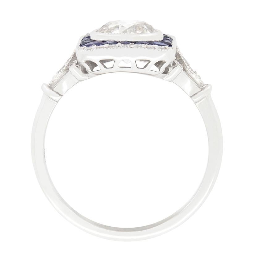 Crafted in the 1980s with a strong Art Deco style this wonderful target ring centres around a single 1.20 carat old cut diamond. The stone has a colour of H and clarity of I1. Rub over set into 18 carat white gold, the diamond is then surrounded by