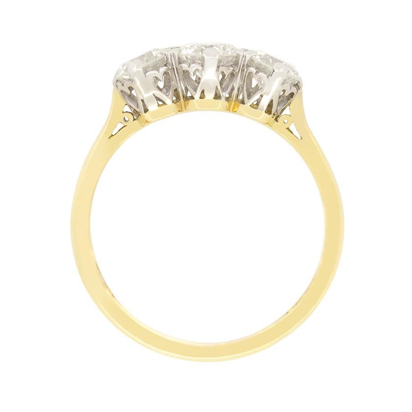 A timeless classic, this vintage trilogy ring dates to the 1970s and features a trio of round brilliant diamonds. The largest of the three sits central at 0.50 carat with the flanking pair weighing 0.35 carat a piece. Each diamond ranges in colour