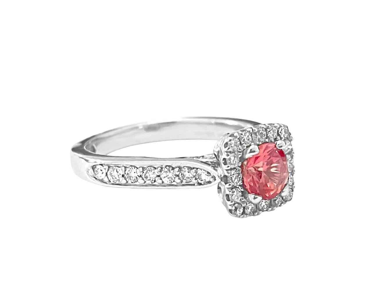 Introducing this beautiful vintage-style ring crafted from 14k white gold, featuring a vibrant 0.45 carat round tourmaline as its centerpiece, complemented by 0.75 carats of round brilliant-cut diamonds with VS clarity and F-G color. With its