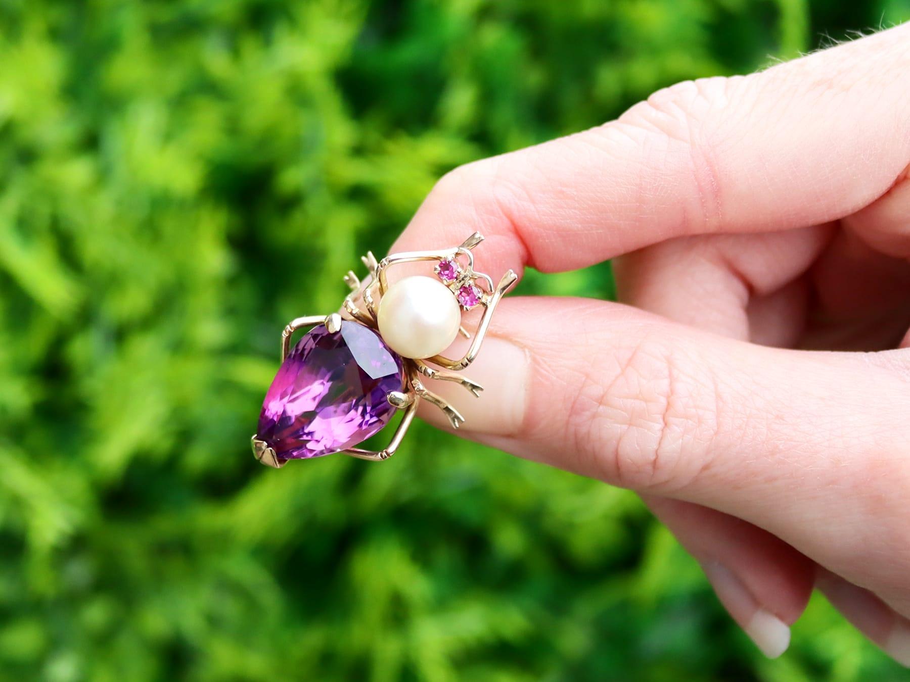 A fine and impressive 12.39 carat amethyst, pearl and 0.06 carat ruby, 14 karat yellow gold 'insect' brooch; part of our diverse vintage jewelry and estate jewelry collections.

This fine and impressive vintage amethyst brooch has been crafted in