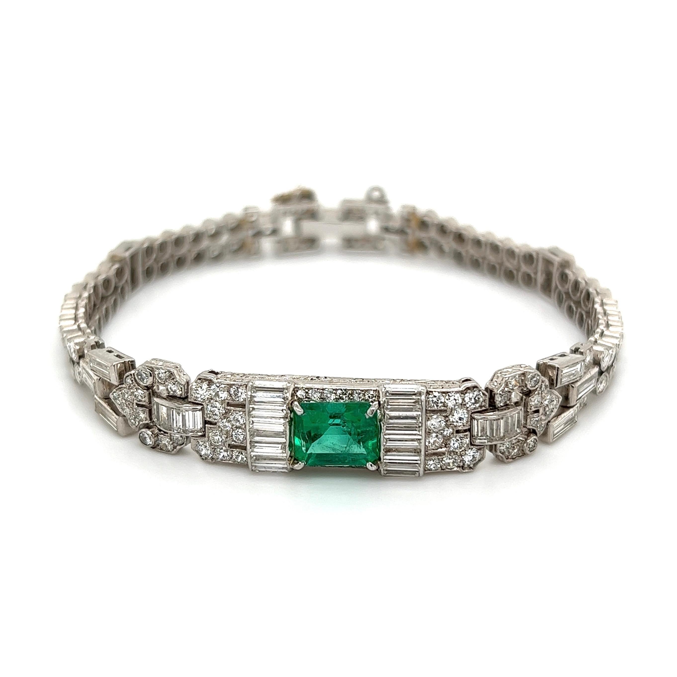 Simply Beautiful! Finely detailed Art Deco Diamond and Emerald Platinum Bracelet. Centering a securely nestled Hand set Emerald-cut Emerald weighing approx. 1.25 Carat surrounded by Diamonds approx. 9.00tcw. Hand crafted Platinum mounting. Bracelet