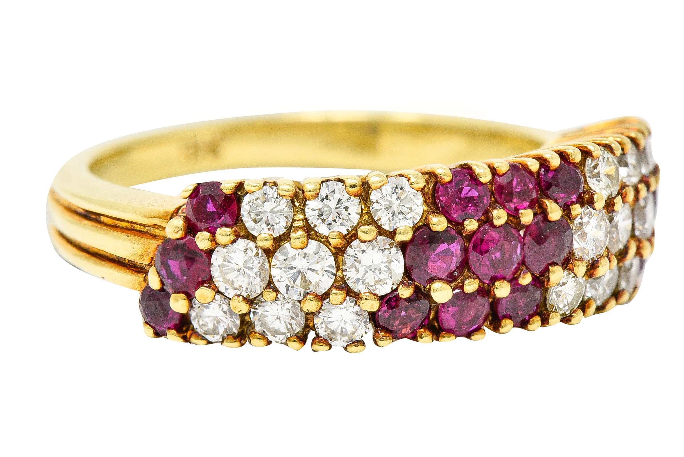 Ring is designed as three rows of prong set round brilliant cut diamonds. Weighing approximately 0.60 carat total - I in color with VS clarity. Alternating with sections of round cut rubies - transparent purplish red in color. Weighing approximately