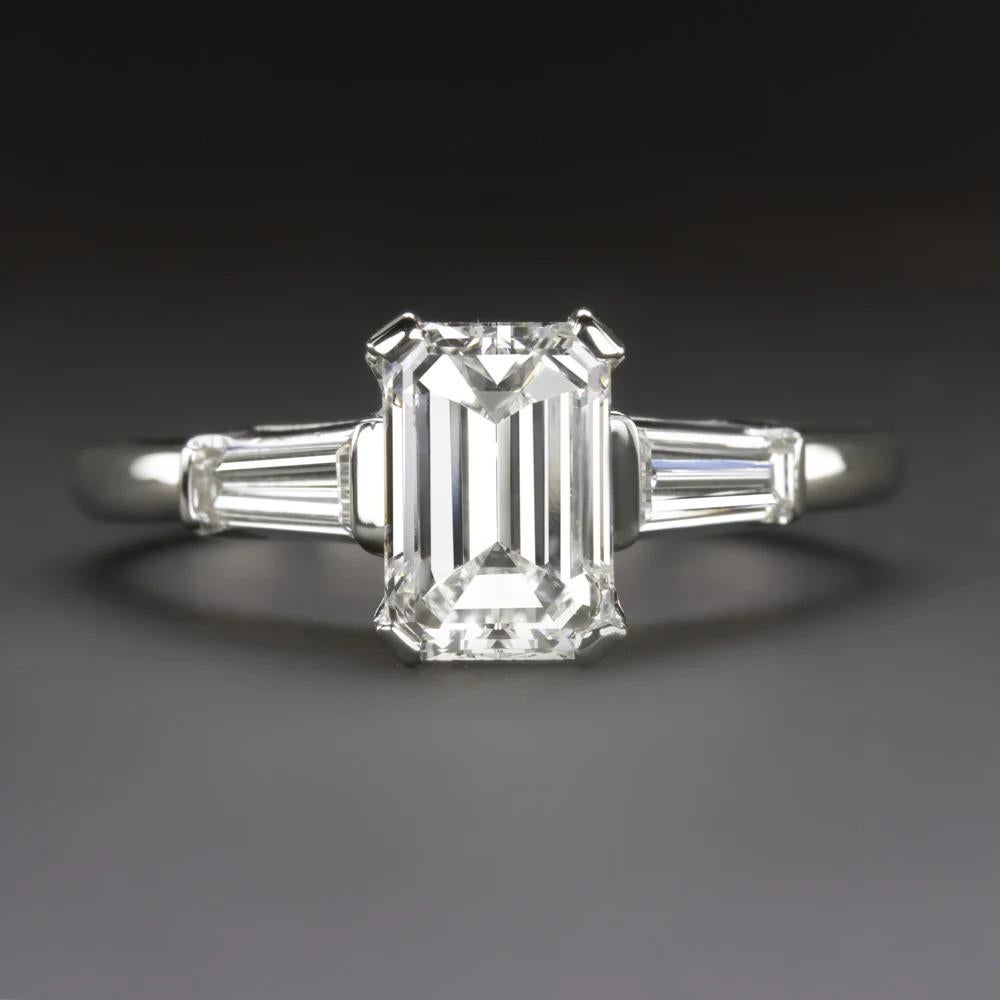 original vintage engagement ring features a substantial 1.26ct emerald cut diamond in and utterly classic platinum setting with tapered baguette diamond accents. It is a high quality ring with a sophisticated design that will stand the test of