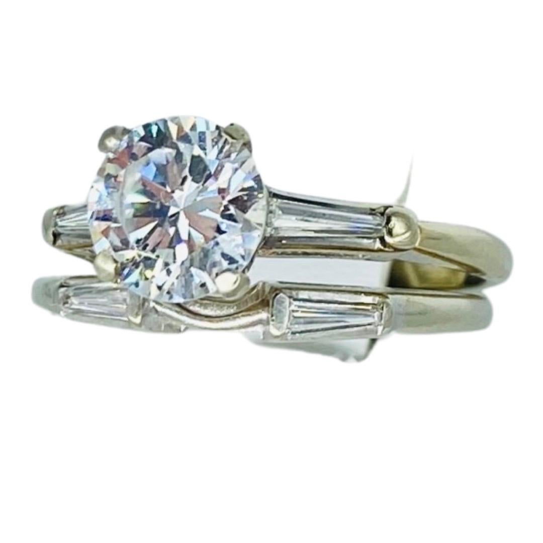 Vintage 1.28 Carat D/I1 Round Diamond Engagement Ring Set 14k White Gold with sides baguette diamonds weights approx 0.40 carat total.
The diamond is a GIA Certified and certificate is included. The ring is a true beauty and is a size 6.25