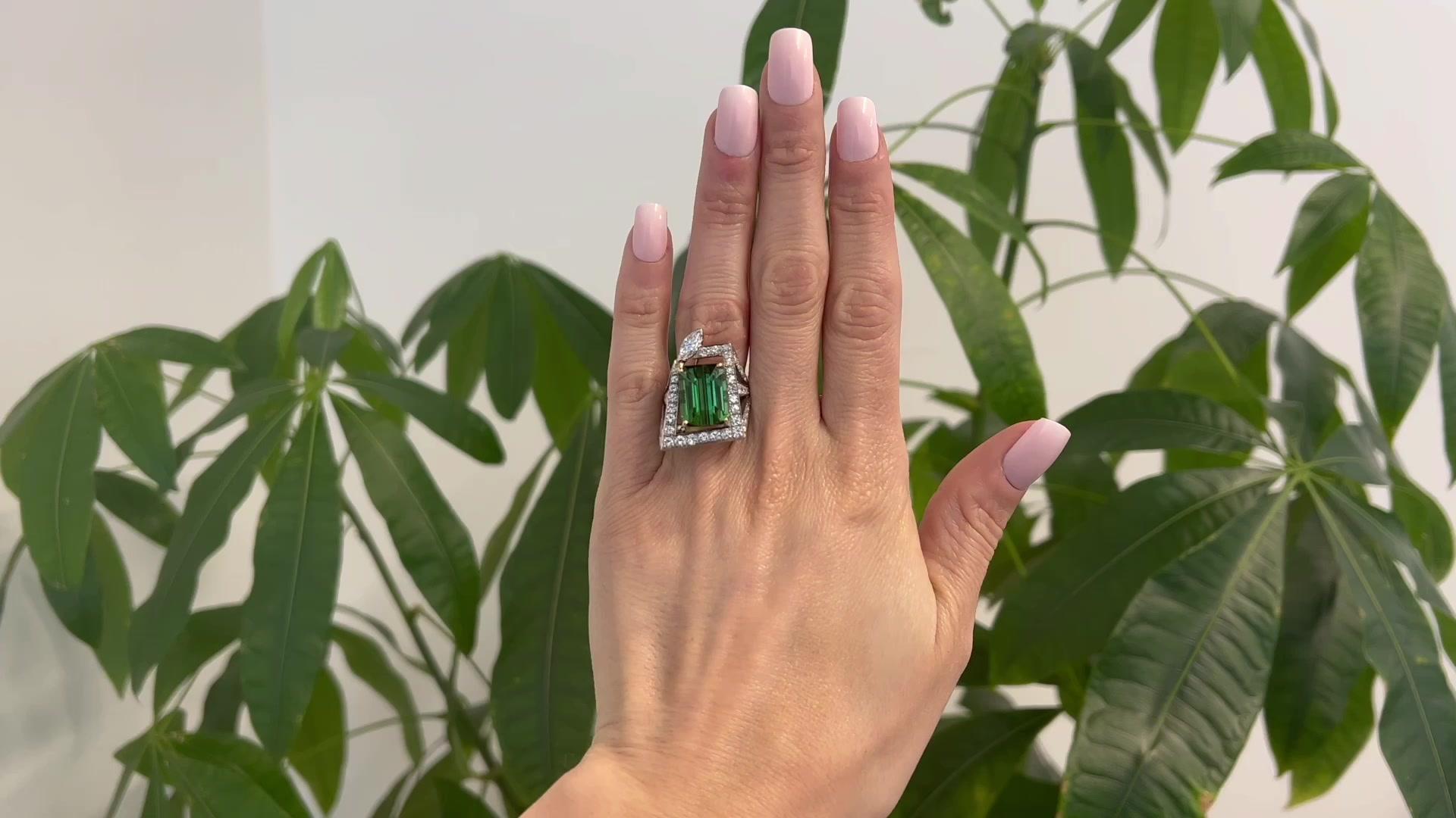 One Vintage 12.86 Carats Green Tourmaline Diamond 14k Two Tone Gold Cocktail Ring. Featuring one octagonal step cut green tourmaline of 12.86 carats. Accented by one marquise cut and 53 round brilliant diamonds with a total weight of approximately