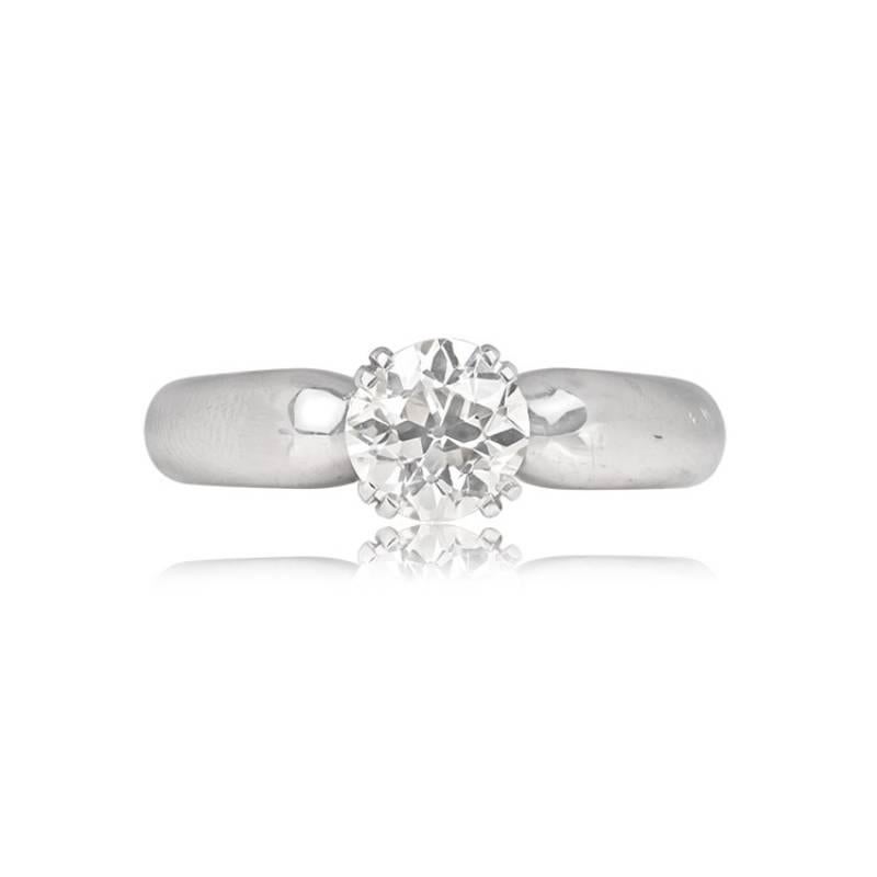 A chic vintage diamond solitaire ring showcases a 1.29-carat old European cut diamond, elegantly set within prongs. The diamond radiates with K color and VS1 clarity, capturing timeless brilliance. Crafted in 18k white gold circa 1980, this ring