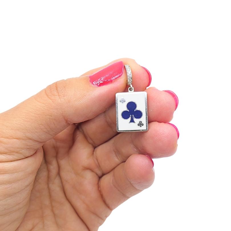 This vintage charm is crafted in 12k gold and features a  playing card design, showcasing the clubs in blue enamel on a white background. The rectangular pendant measures approximately 7/16
