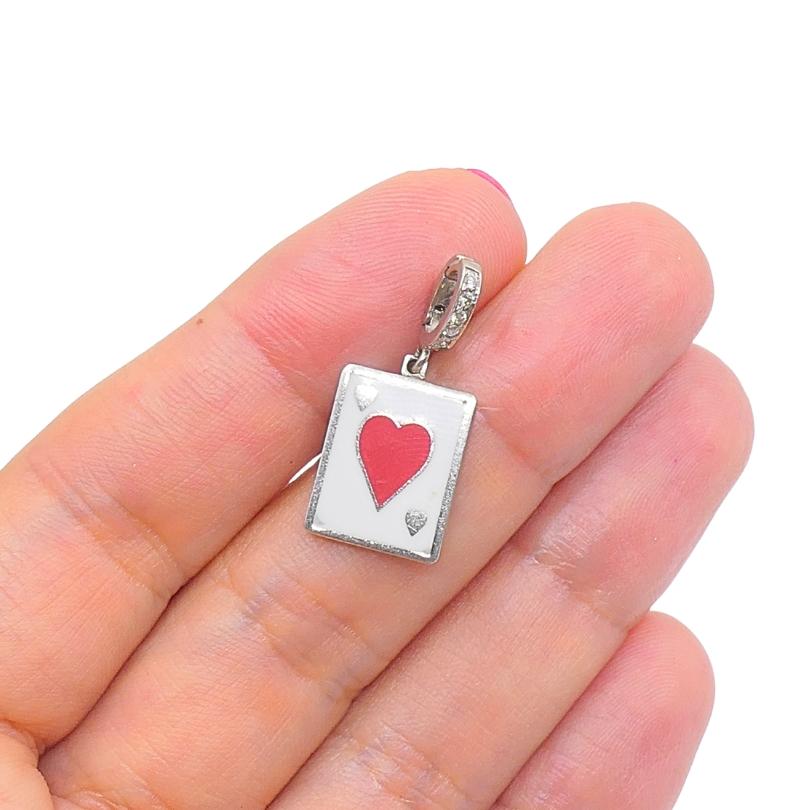 
This vintage charm is crafted in 12k gold and features a  playing card design, showcasing the heart suit motif  in red enamel on a white background. The rectangular pendant measures approximately 7/16