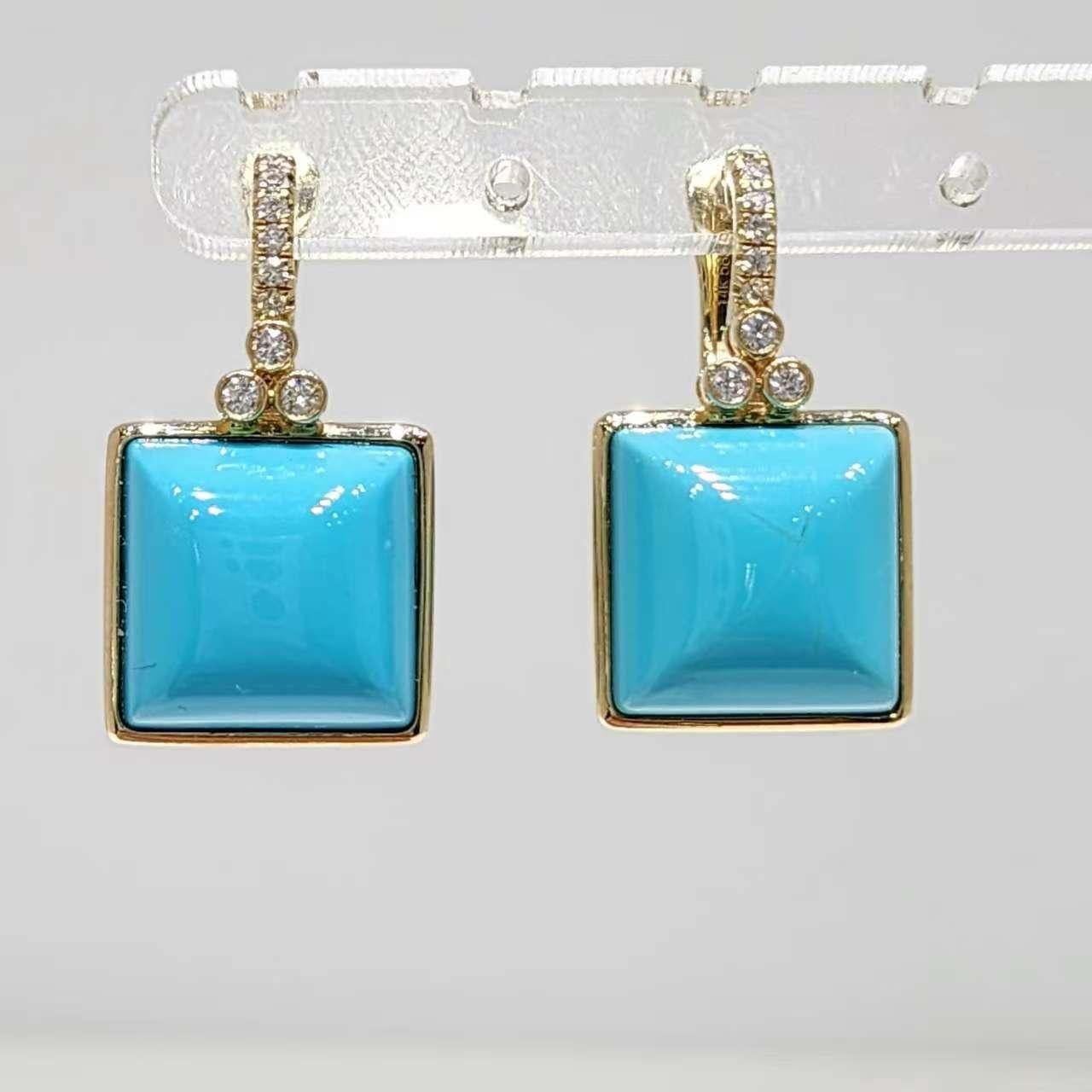 Dive into oceanic elegance with our 14K yellow gold turquoise earrings, featuring stunning 12mm cabochon turquoise stones that capture the serene beauty of turquoise jewelry. Each drop earring showcases a vibrant, sky-blue turquoise square framed in