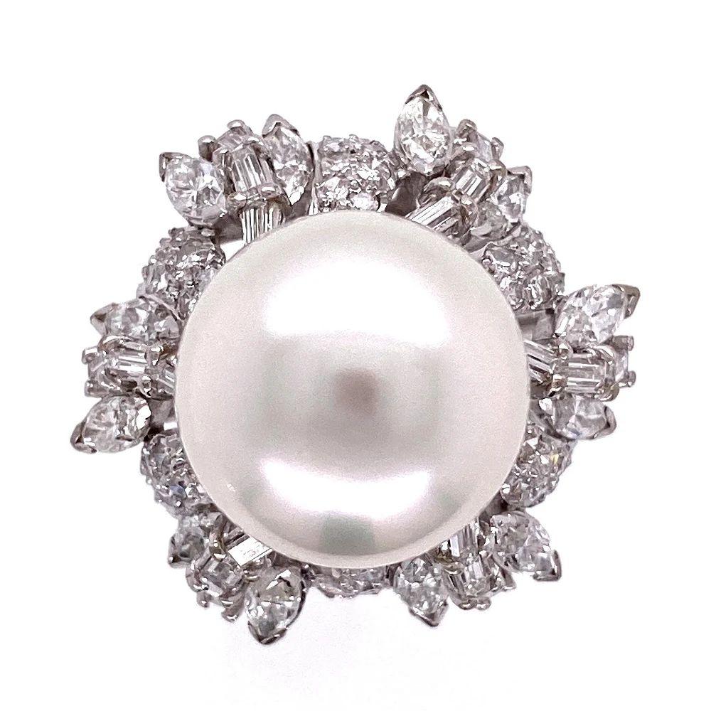 Simply Beautiful! Finely detailed White South Sea Pearl and Diamond Cocktail Ring. Center securely nestled with a Hand set 12mm White South Sea Pearl with almost no blemishes surrounded by approx. 2.45tcw Marquise, Baguettes and round Single-cut