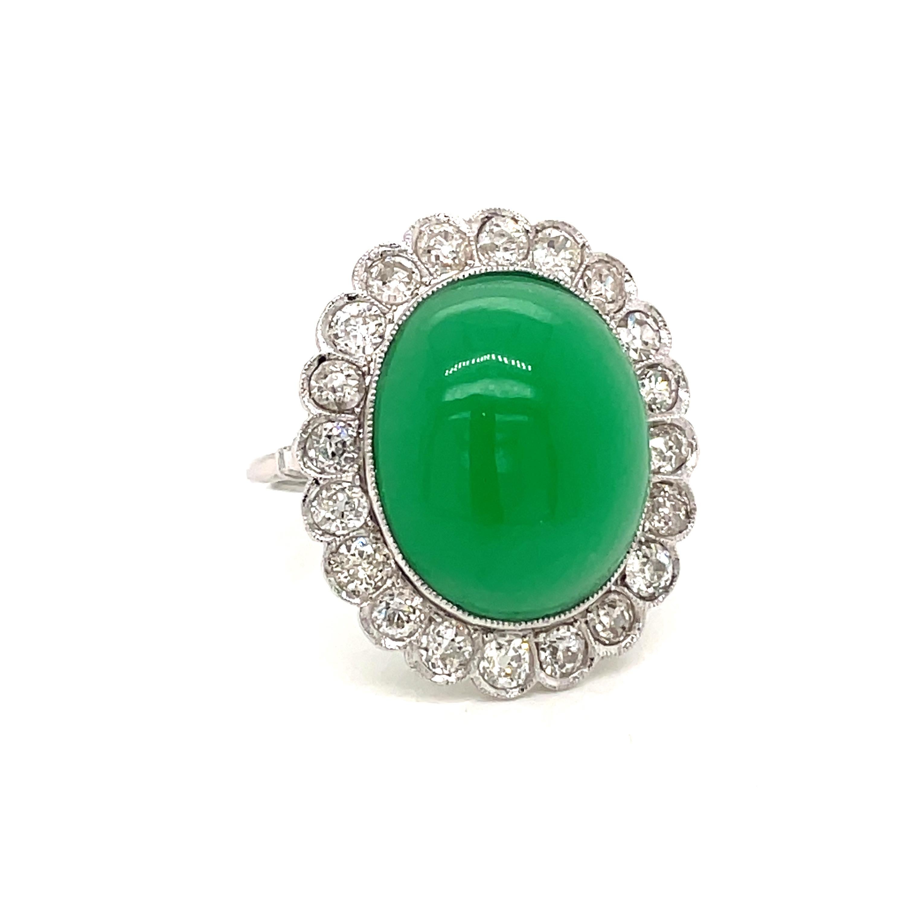 Platinum Diamond Ring, set in the center with a Beautiful oval cabochon Jade weighing 13 carat framed by a round halo consisting of 2 carat of old mine cut diamonds graded H color and Vs clarity.
Circa 1980

CONDITION: Pre-owned - Excellent
METAL:
