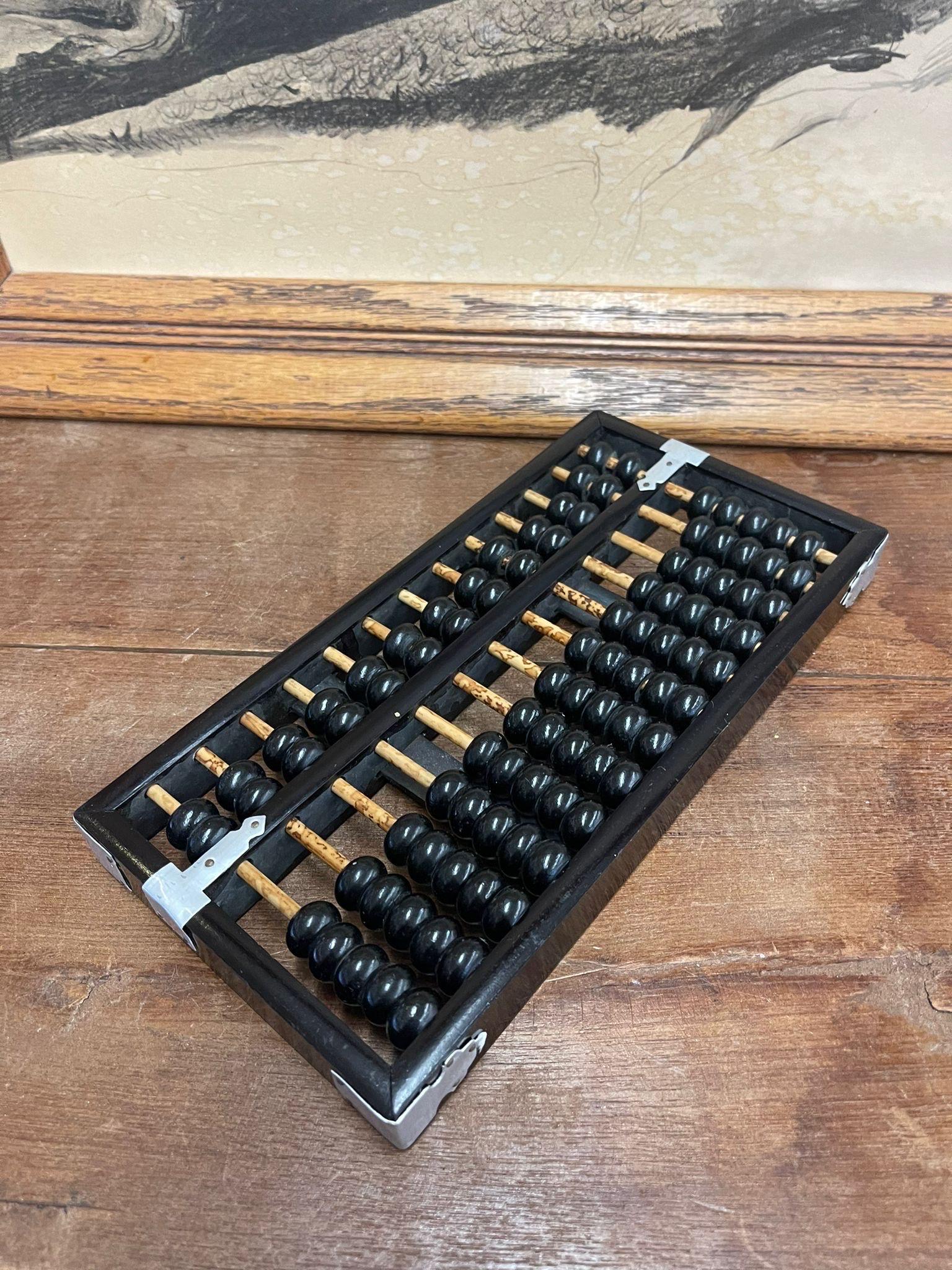 This Abacus has black painted wood framing and beads. The rods have been left unpainted, showcasing beautiful wood grain. Vintage Condition Consistent with Age as Pictured.

Dimensions. 9 2/2 W ; 5 D ; 1 H