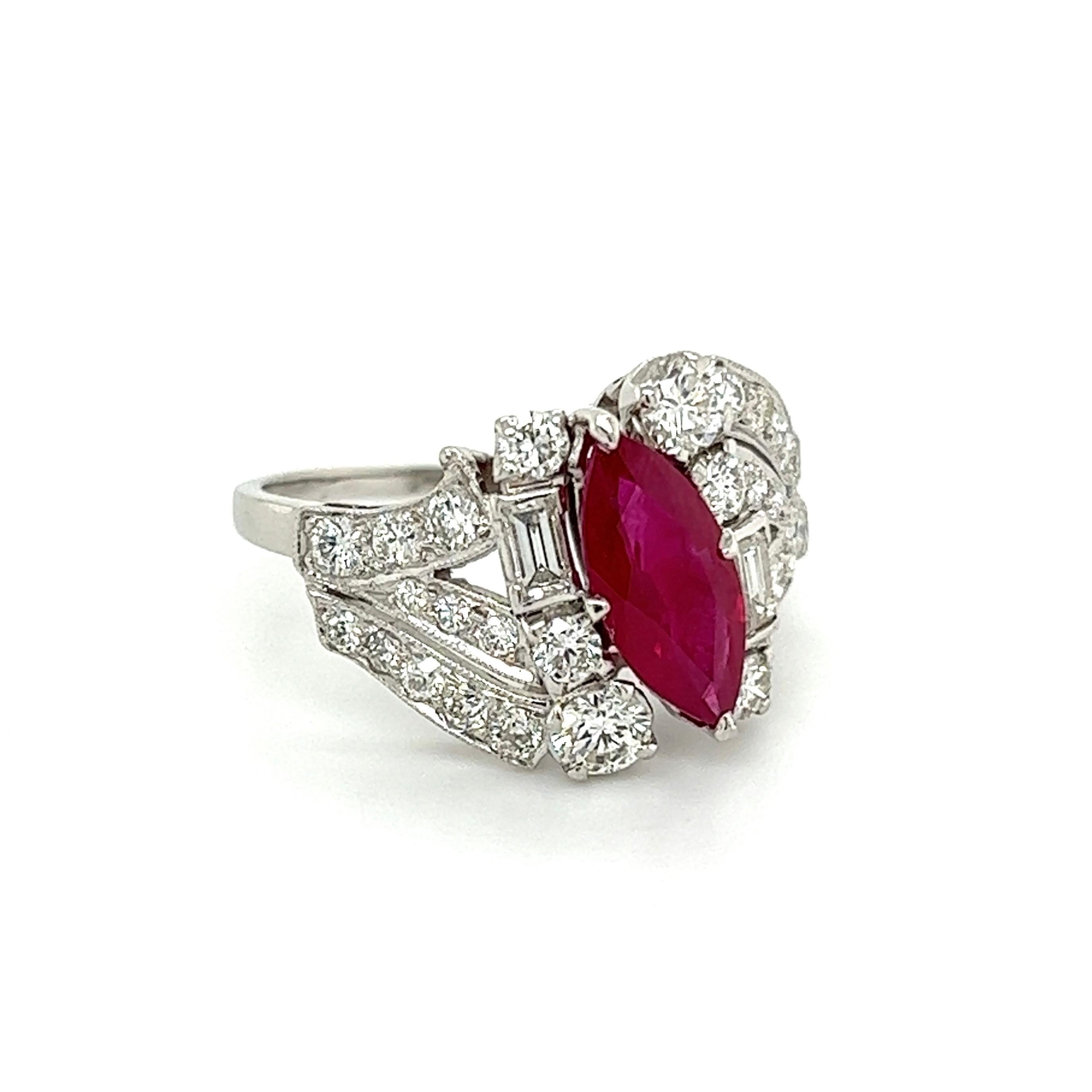 Simply Beautiful! Marquis Red Ruby and Diamond Platinum Ring. Centering a securely nestled Hand set 1.30 Carat Marquis Ruby, artistically surrounded by Diamonds, approx. 1.70tcw. Hand-crafted Platinum mounting. Ring size 6.75, we offer ring