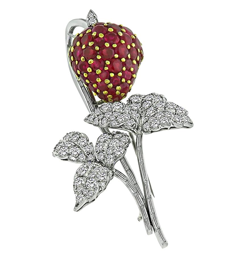 This is a gorgeous platinum strawberry pin from the 1950s. The pin is set with round cut rubies that weigh approximately 13.00ct. The rubies are accentuated by round and baguette cut diamonds that weigh approximately 1.50ct. The color of these