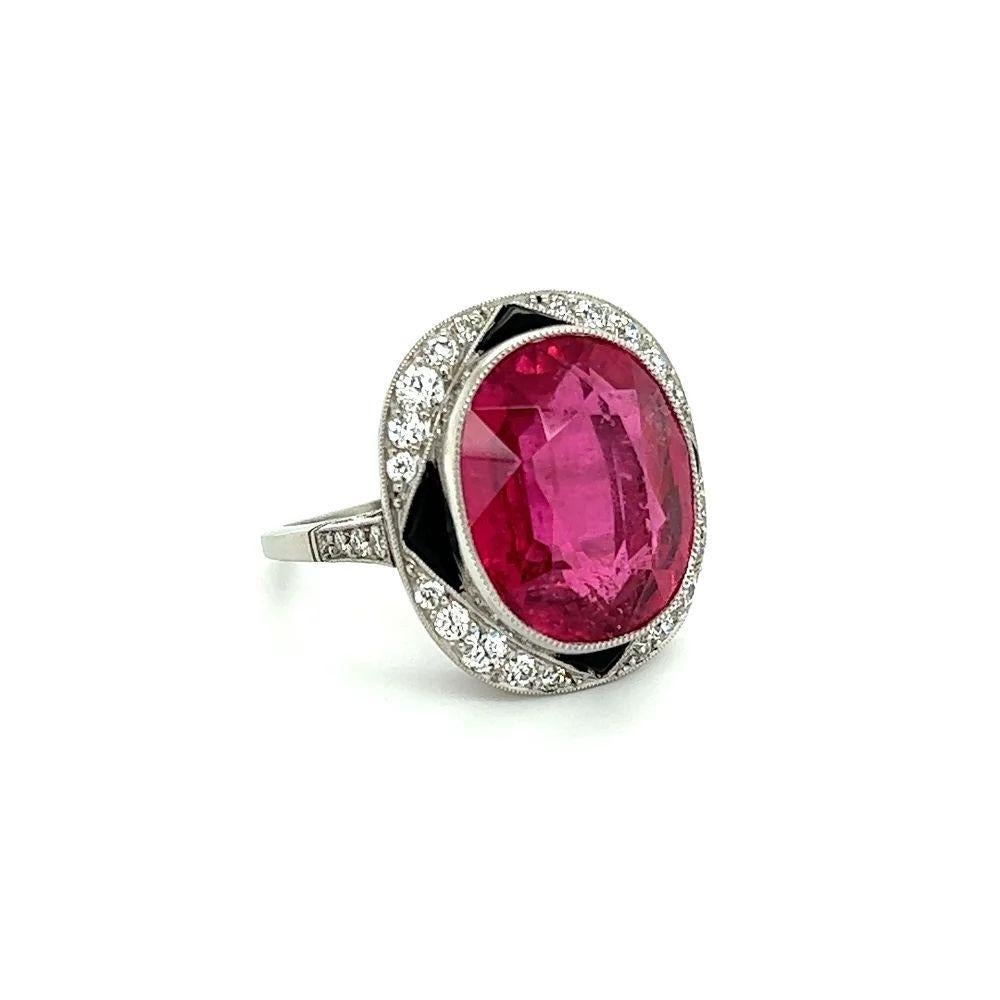 Simply Beautiful! Vintage Rubellite Tourmaline, Onyx and Diamond Platinum Cocktail Ring. Centering a securely nestled Hand set 13.18 Carat Rubellite Tourmaline, surrounded by Old European Cut Diamonds, weighing approx. 0.55tcw and accented by Onyx,