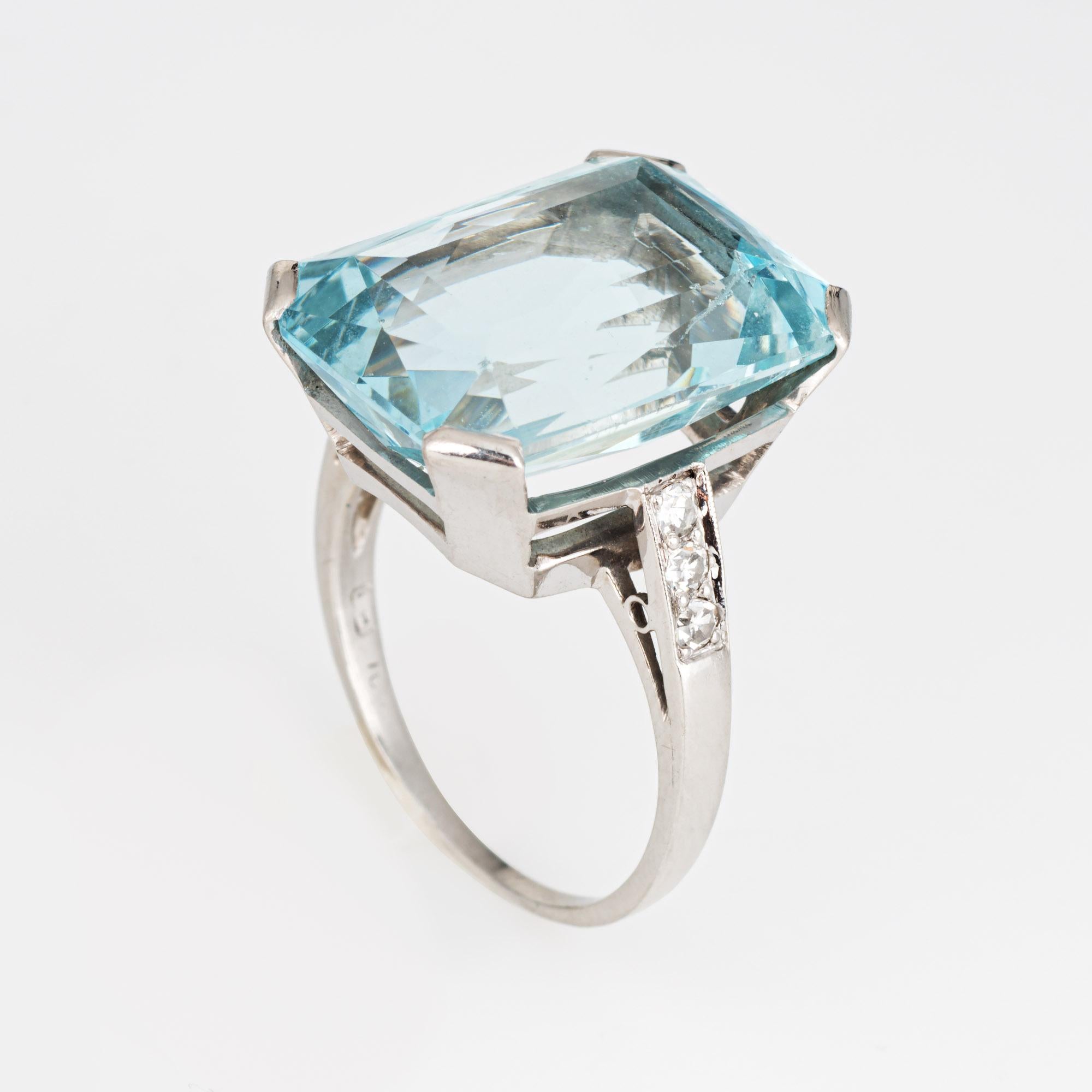 Stylish vintage aquamarine & diamond cocktail ring (circa 1920s to 1960s) crafted in 900 platinum. 

Faceted emerald cut aquamarine measures 17.5mm x 13mm (estimated at 13.50 carats), accented with 6 single cut diamonds totaling an estimated 0.03