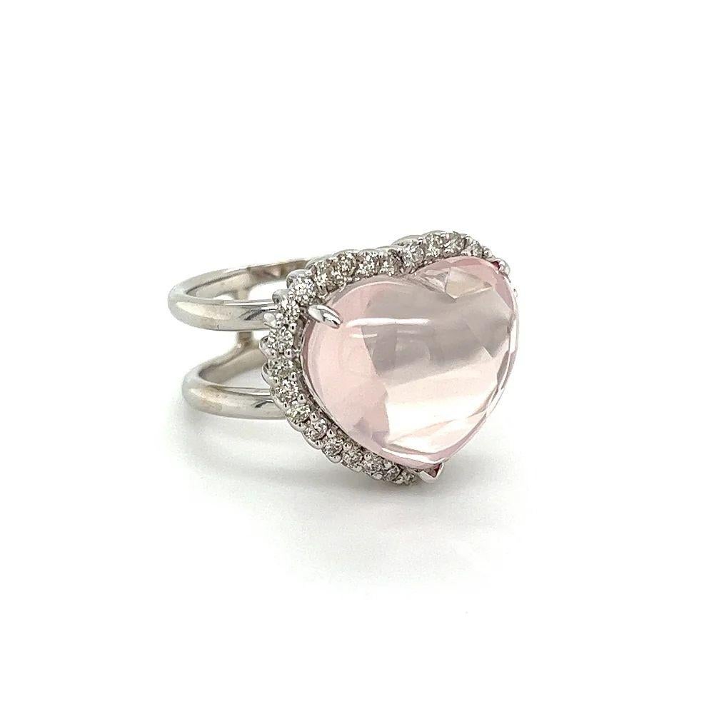 Simply Beautiful! Heart Shape Pink Quartz and Diamond Solitaire Gold Ring. Centering a securely nestled Hand set 13.65 Carat Pink Quartz, surrounded by Diamonds, weighing approx. 0.58tcw. Hand-crafted Double shank 18K White Gold mounting. Ring size: