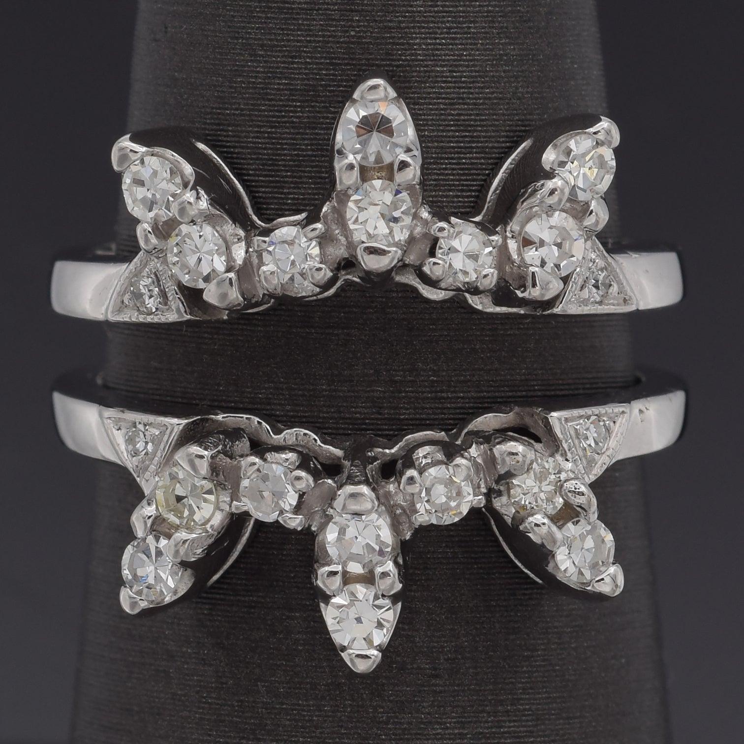 A vintage 14K white gold diamond enhancer ring guard designed to add brilliance and dimension to a solitaire or engagement ring. This elegant guard features an array of sparkling round diamonds set in a decorative, crown-like arrangement, enhancing