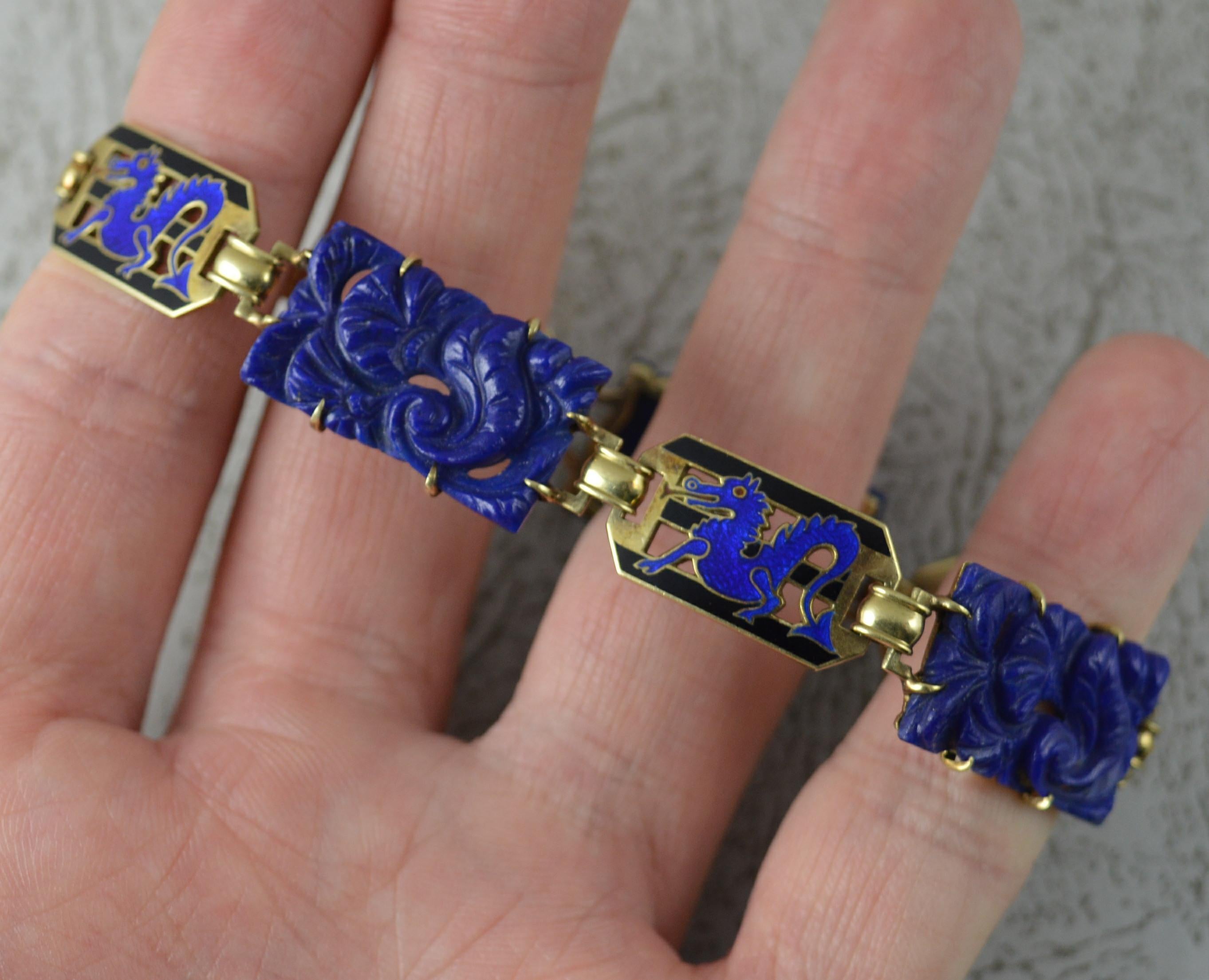 A superb vintage bracelet.
Solid 14 carat yellow gold example.
Designed with three deep relief hand carved lapis lazuli panels with enamel panels in between of blue and black colour depicting a dragon.

CONDITION ; Very good for age. Clean design.