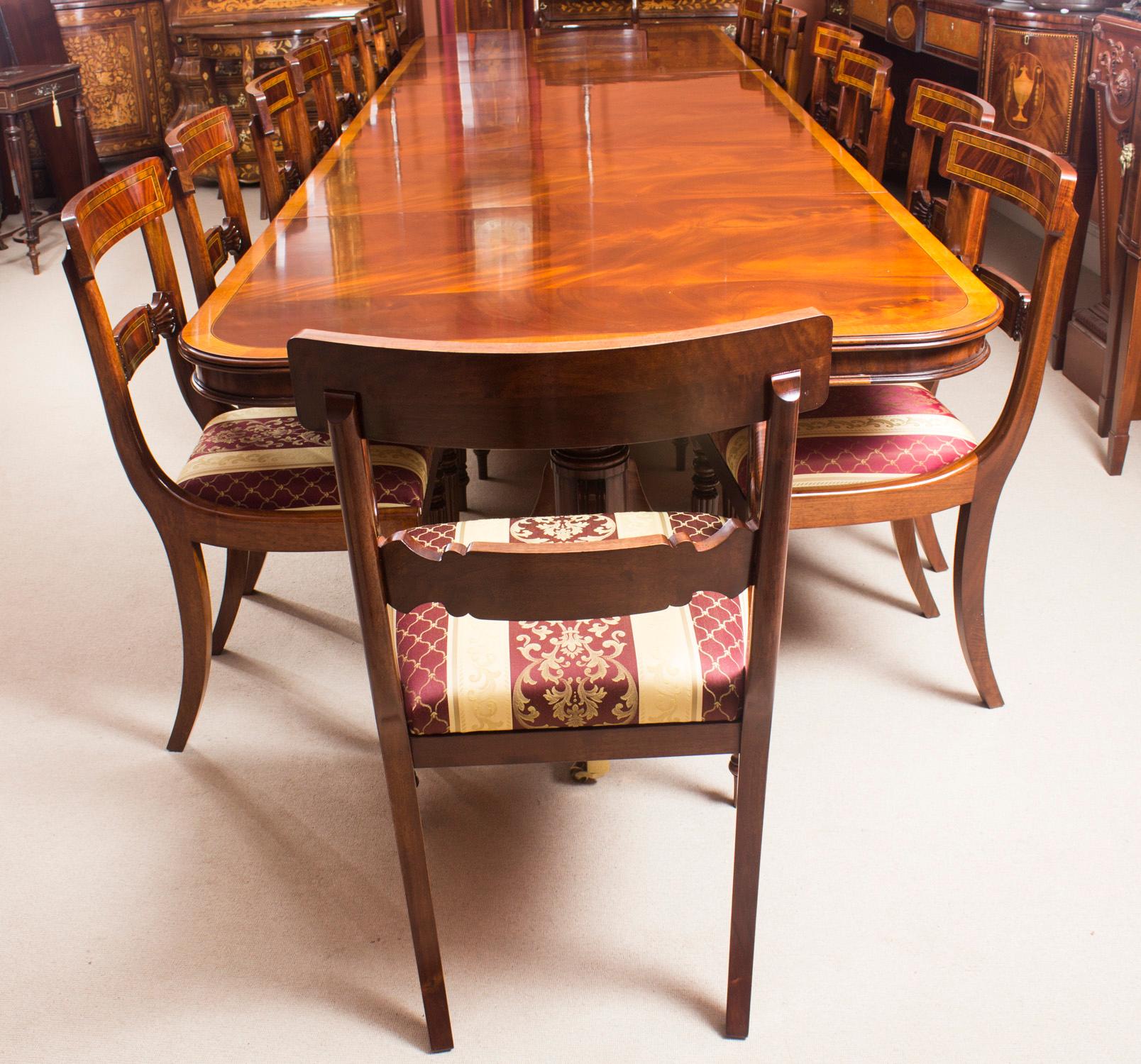This is a superb vintage Regency Revival dining set crafted in flame mahogany and featuring superb satinwood crossbanded decoration to the table and chairs. dating from the  second half of the 20th Century.

It comprises a Regency Revival dining