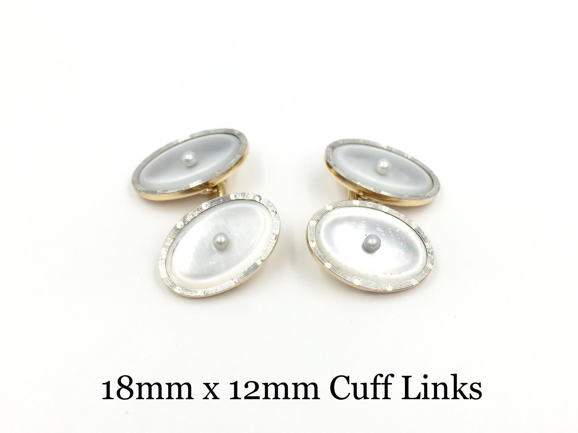 Circa 1930's vintage mother of pearl and two tone gold cuff link set. Set includes two different sized round shirt studs, both in a set of three. Beautiful oval gold linked cuff links as well as two mother of pearl collar studs. One small seed pearl