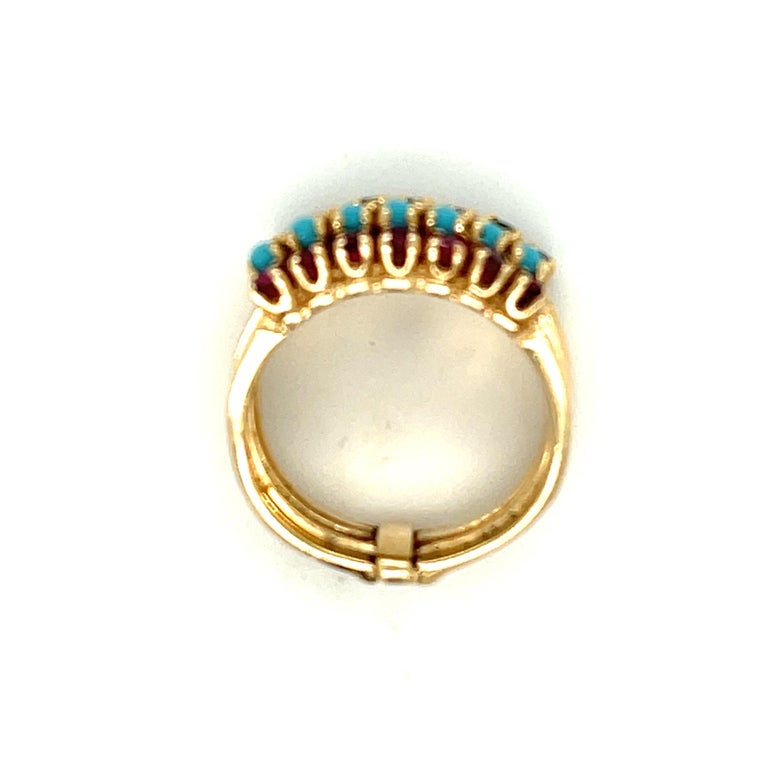 A charming vintage 14k yellow gold harem ring set with sapphires, emeralds, diamonds, turquoise and rubies, circa 1970. This harem ring is so called based upon Victorian depictions and fascination with Eastern Oriental culture. It refers to a multi