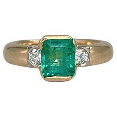 Vintage 14 Karat Gold 1.10 Carat Emerald 0.21 Carat Diamond Three-Stone Ring