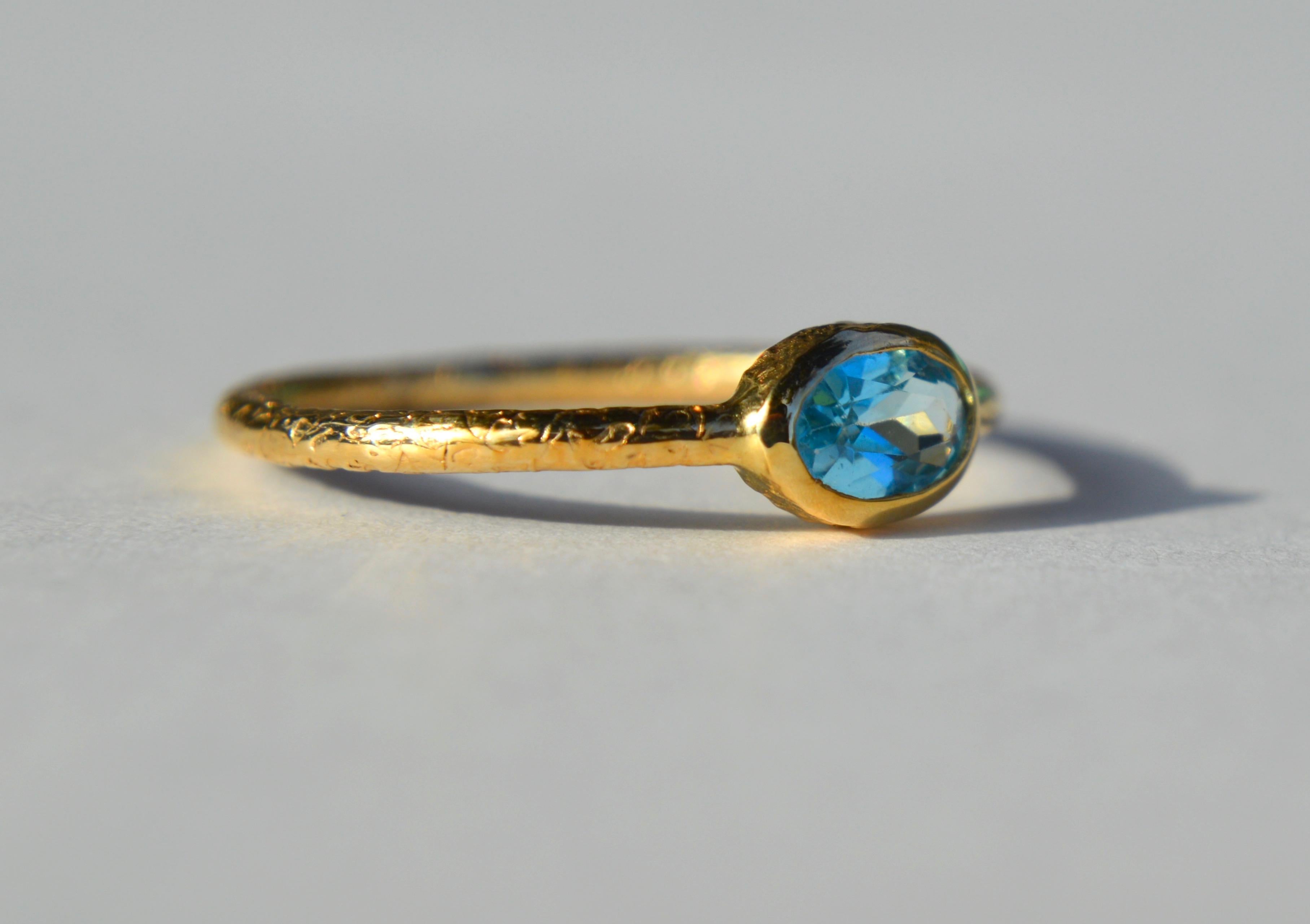 Lovely vintage 1980s 14K yellow gold .70 carat bezel set natural aquamarine thin textured stacking or  alternative engagement ring. In very good condition. Size 8, can be resized by a jeweler. Marked as 14K gold. Made in Turkey.

Aquamarine is the