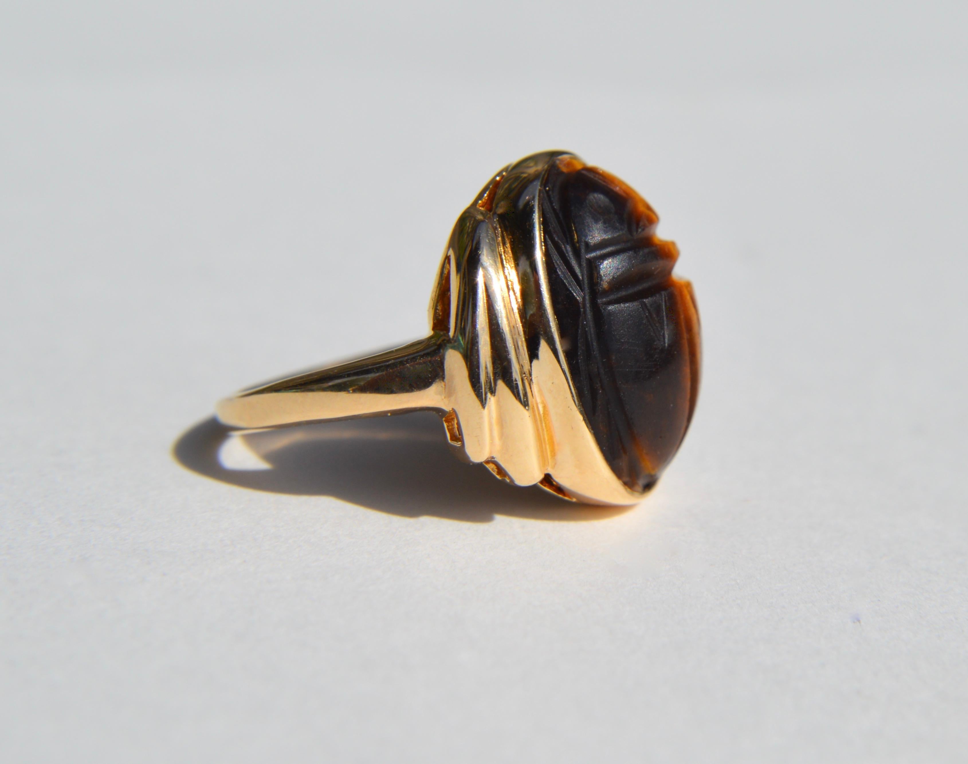 Beautiful vintage 10K yellow gold tiger'ss eye scarab beetle ring. Size 4.25, can be resized by a jeweler. In very good condition. Ring is unmarked, but acid tested as solid 10K gold. Stone measures 15x11 mm.

Tiger's eye properties:
A stone of