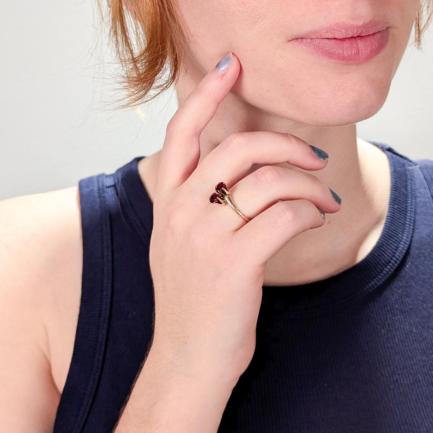 A fine vintage garnet and 14K gold ring.

In the 'Toi et Moi' form (meaning in French 'You and Me') with 2 deep red, round-cut garnet gemstones that are prong set in 14K gold.

A classic style symbolizing love and connection!

Ring Size: ca. 7