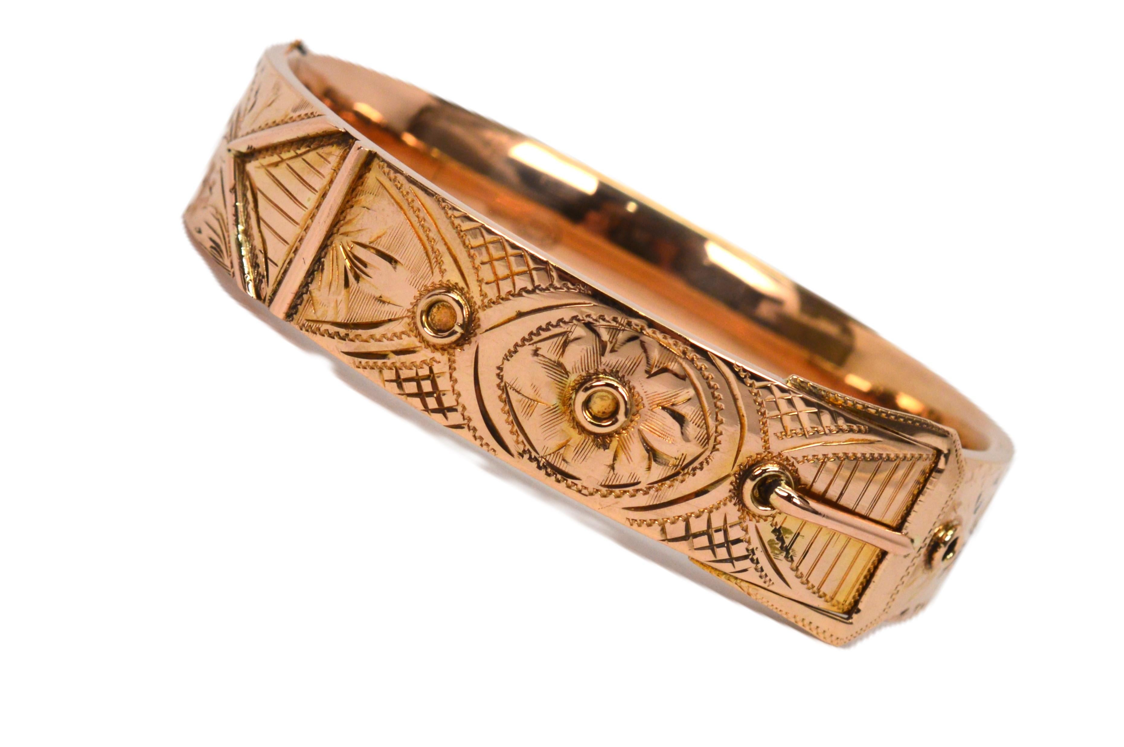 Hand chased in 14 karat yellow gold with rose undertones, intricate patterns grace the front of this unique vintage bangle bracelet signed by I. Berman. A 5/8 wide belt buckle design with the dimensional details for its buckle frame, prong and