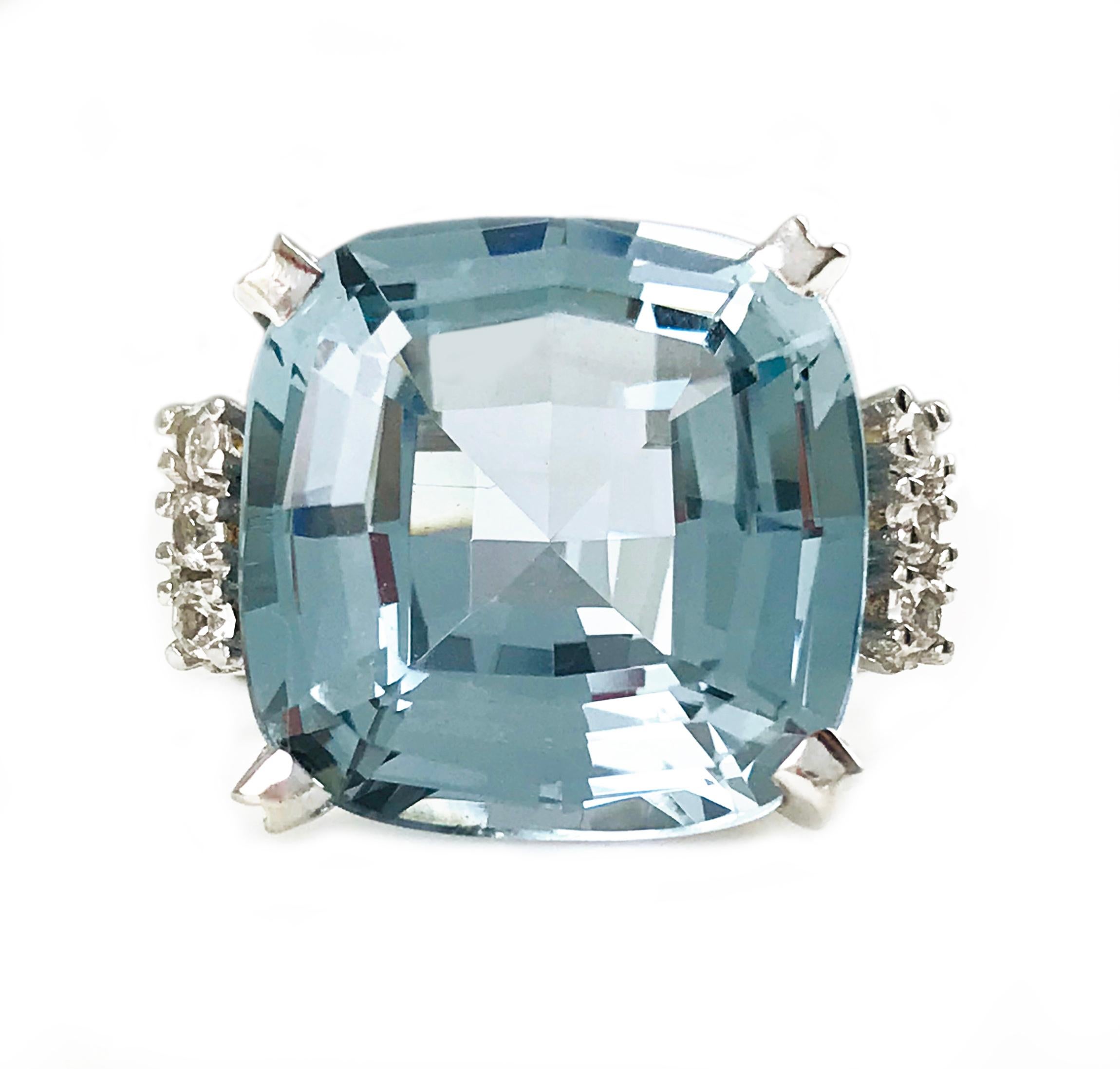 Vintage Retro 14 Karat White Gold Fancy Cut Blue Quartz. The stone measures 14.5 x 14.5 x 8.5mm. A row of three 2mm prong-set round diamonds add an extra sparkle to each side of the large center four prong-set blue quartz. Stamped on the inside of