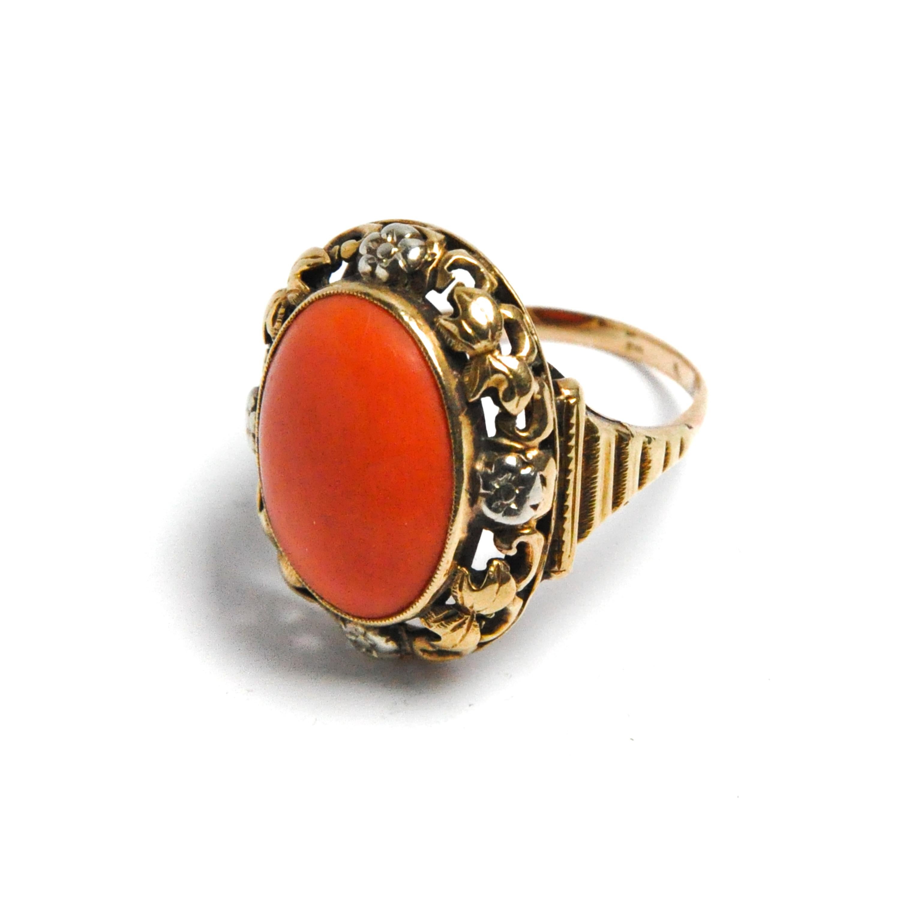 A vintage 14 karat gold ring set with a natural cabochon coral. The coral is set in a rich decorated gold frame. The gold has a beautifully openwork structure with flowers and curls. 

The *coral ring is in good condition. Marked. Tested as 14k