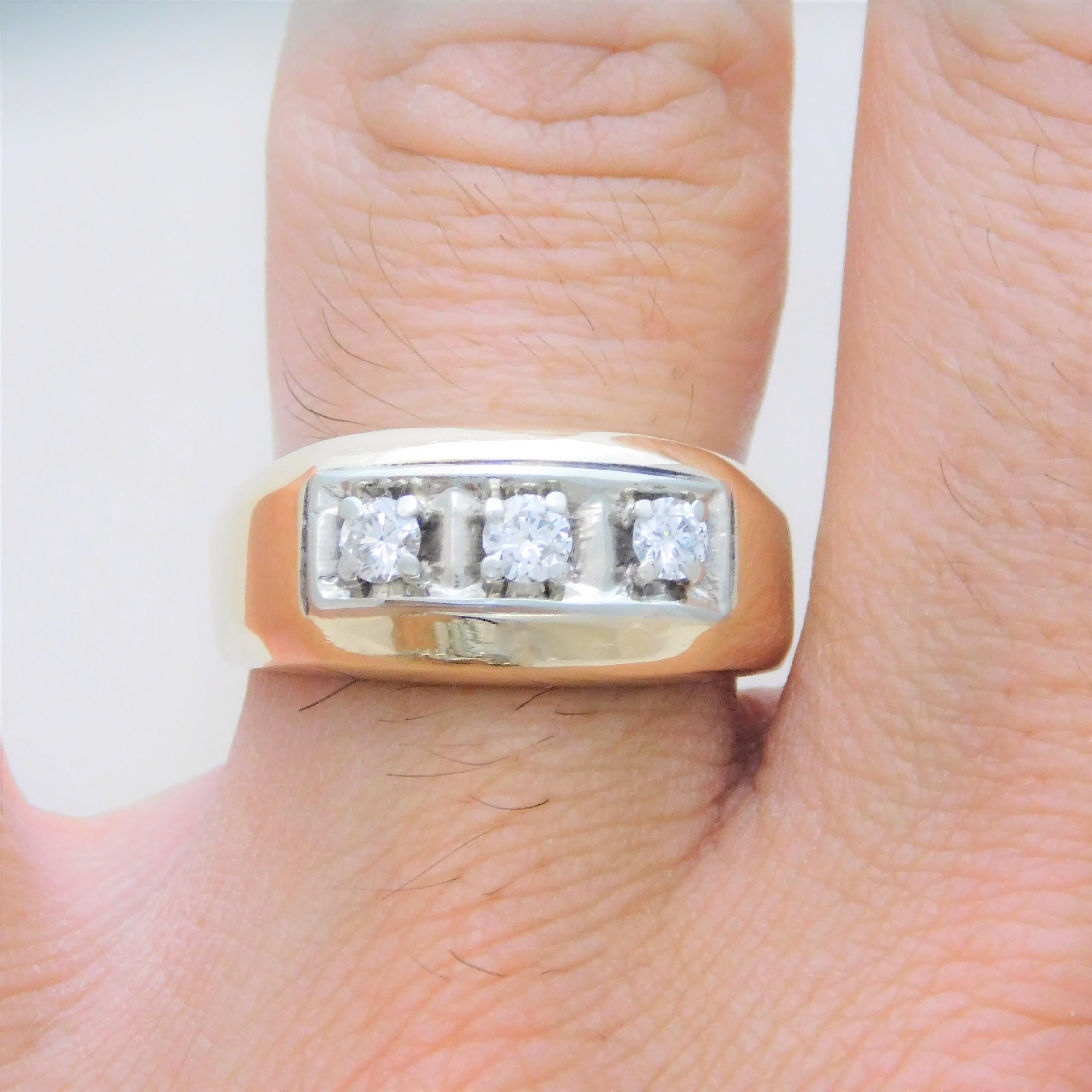 A Southern family heirloom.  Circa 1970-1980.  This gent’s heavy diamond three-stone ring has been crafted in solid 14k yellow gold.  It has been jeweled with three high quality natural round brilliant-cut diamonds approximating 0.60ct in total