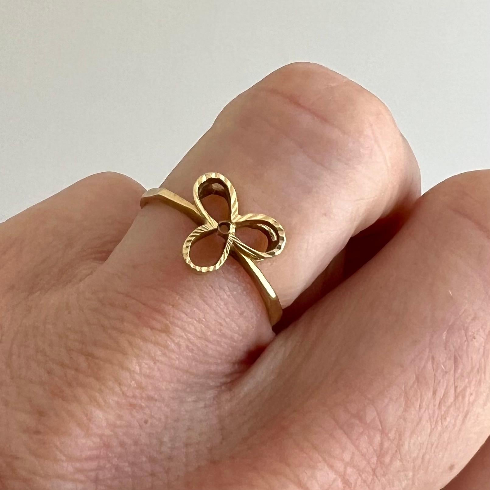 This exquisite 14-karat gold ring embodies both elegance and symbolic meaning, making it a perfect piece for everyday wear or special occasions.

The band of the ring is smooth and polished, offering a sleek and timeless look that ensures comfort