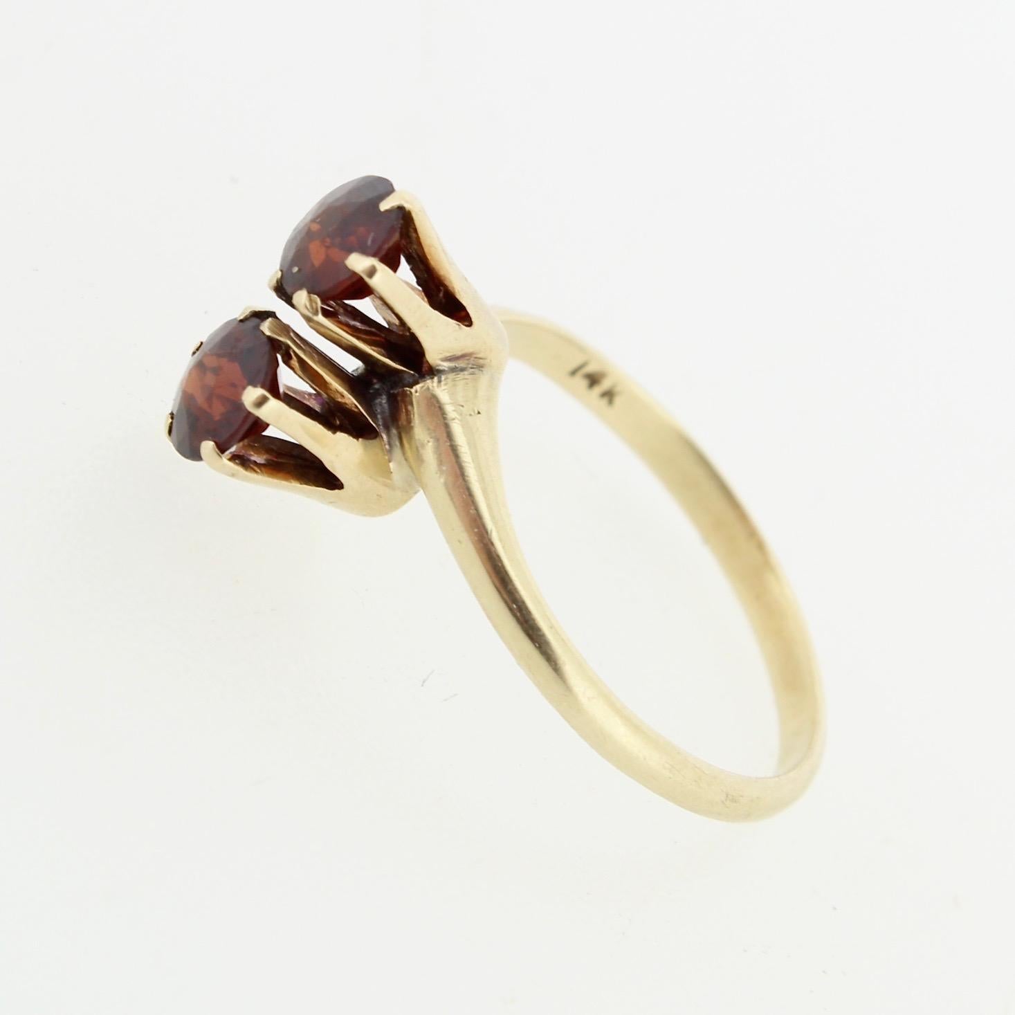 A fine vintage garnet and 14K gold ring.

In the 'Toi et Moi' form (meaning in French 'You and Me') with 2 deep red, round-cut garnet gemstones that are prong set in 14K gold.

A classic style symbolizing love and connection!

Ring Size: ca. 7