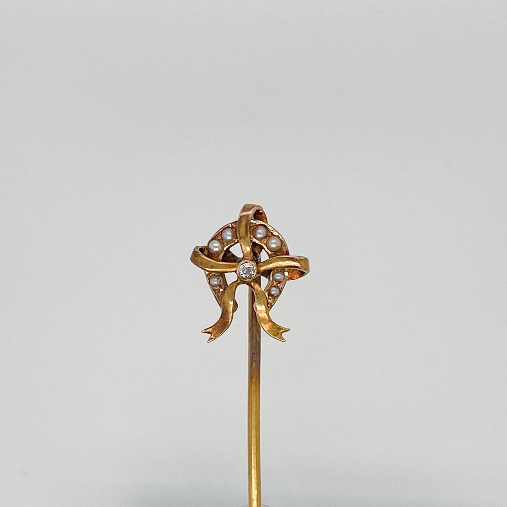 A very fine 14k yellow gold horseshoe & ribbon stickpin.

With small seed pearls pave set in the horseshoe and with a small round brilliant diamond flush set at the center of the ribbon.

Simply a great stickpin!

Date:
19th Century or Early 20th