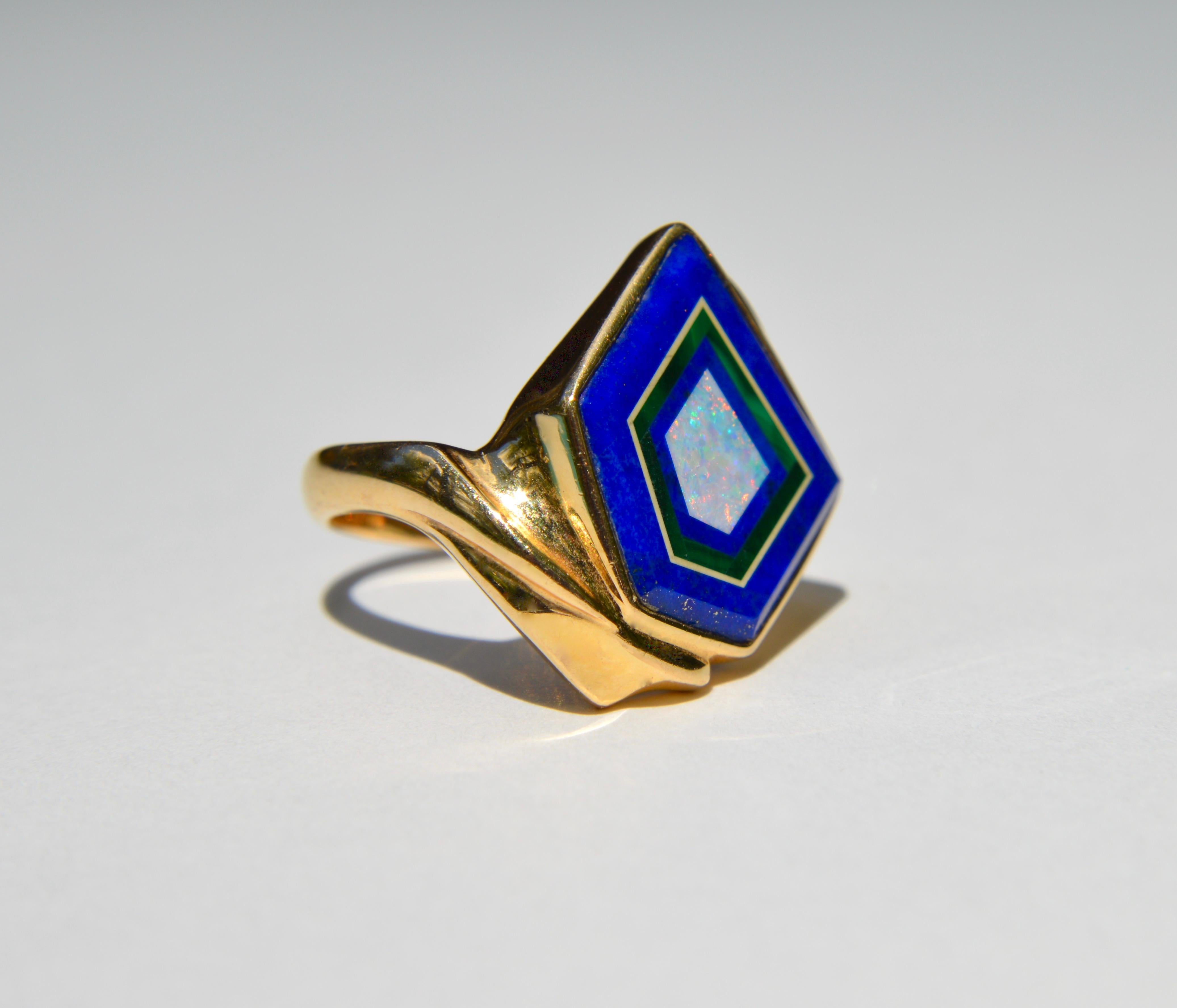 Gorgeous vintage Midcentury era circa 1970s 14K yellow gold geometric inlay ring featuring lapis lazuli with pyrite flecks, malachite, Australian opal, and 3 diamond accents on one shoulder. Marked and tested as 14K gold. In excellent  condition.