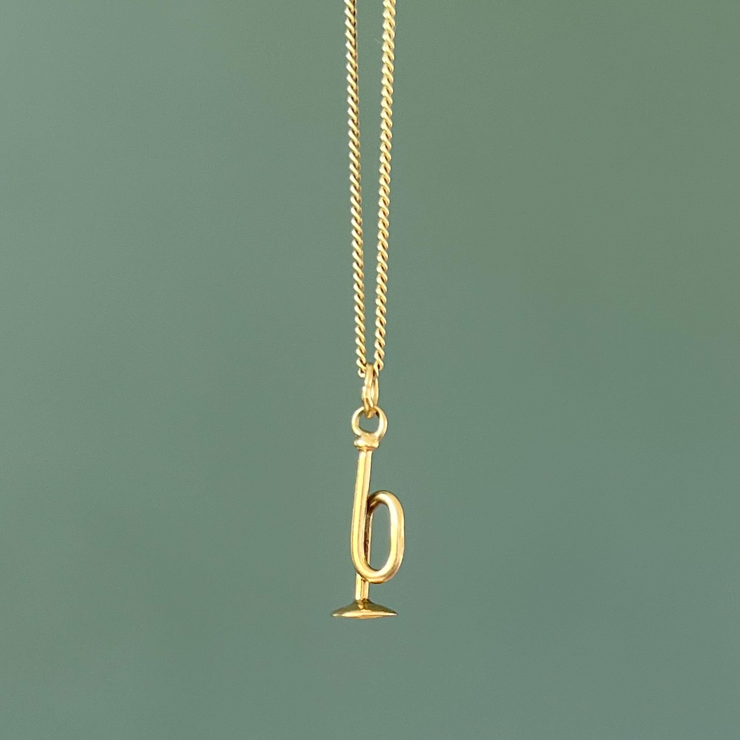 A lovely vintage three-dimensional trumpet charm pendant. The trumpet is nicely polished and created in 14 karat yellow gold. The great thing about charms is that you can collect them as wearable memories and add them to your necklace, charm