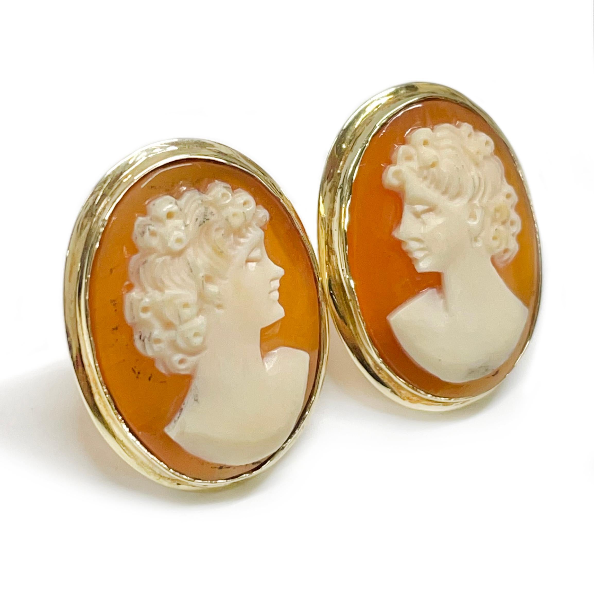 Vintage 14 Karat Shell Cameo Earrings. The earrings feature a bezel-set traditional lady cameo with post and Omega clip back. Each earring measures approximately 20 x 15mm. On one earring the lady is facing left and on the other the lady is facing