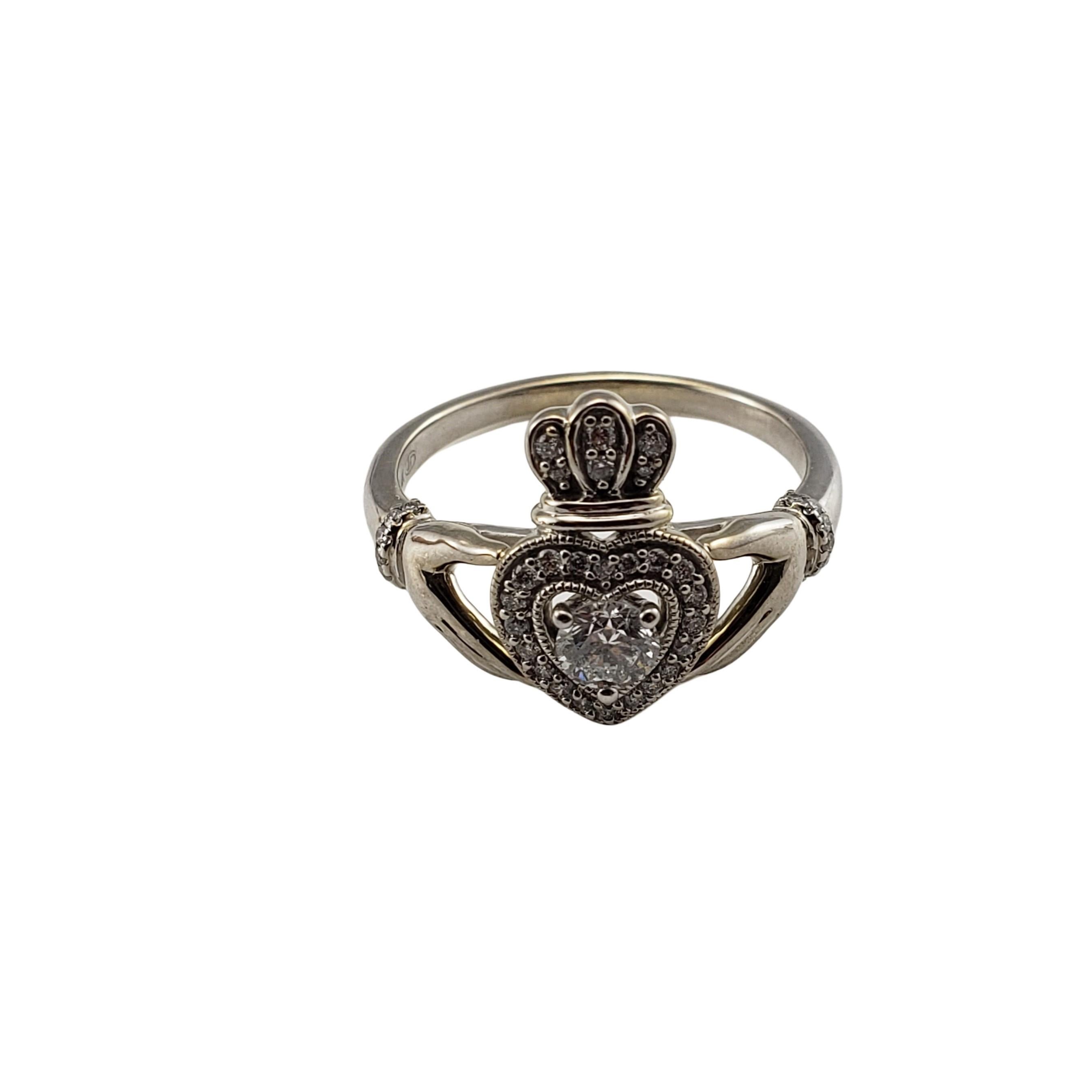Vintage 14 Karat White Gold and Diamond Claddagh Ring Size 6.75-

This lovely Claddagh ring features 41 round brilliant cut diamonds (center: .20 ct.) set in classic 14K white gold.  Shank: 2 mm.

Approximate total diamond weight:  .45 ct.

Diamond